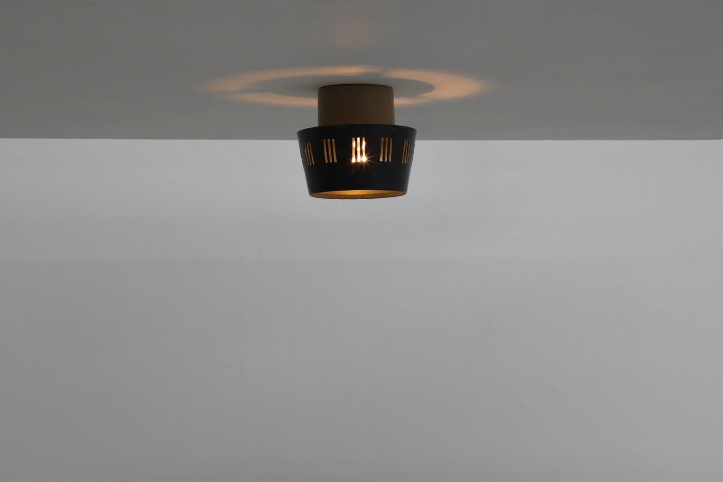 Philips NT 52 E/00 industrial flush mount ceiling lamp with dark grayish blue enameled shade, cut-out design and beige base. In original condition with visible wear including some scratches, possible denting, as well as age spotting and some enamel