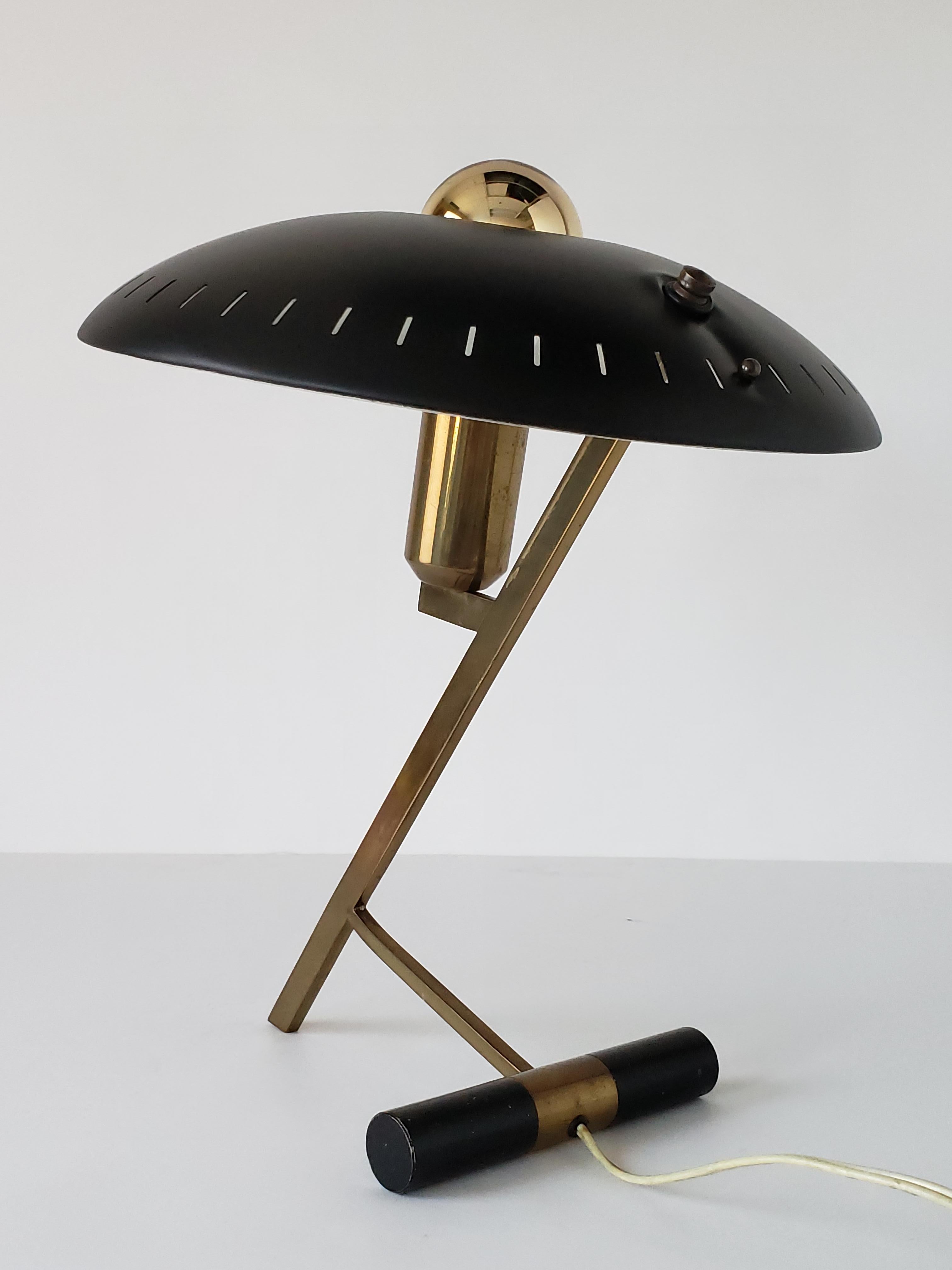 Iconic Dutch desk/table lamp by designer and architect Louis Kalff for the Philips Company. 

Enameled black aluminium shade sitting on a solid brass frame and base.

E27 socket rated at 60 watt. 

Displayed here with a gold top 60 watt light