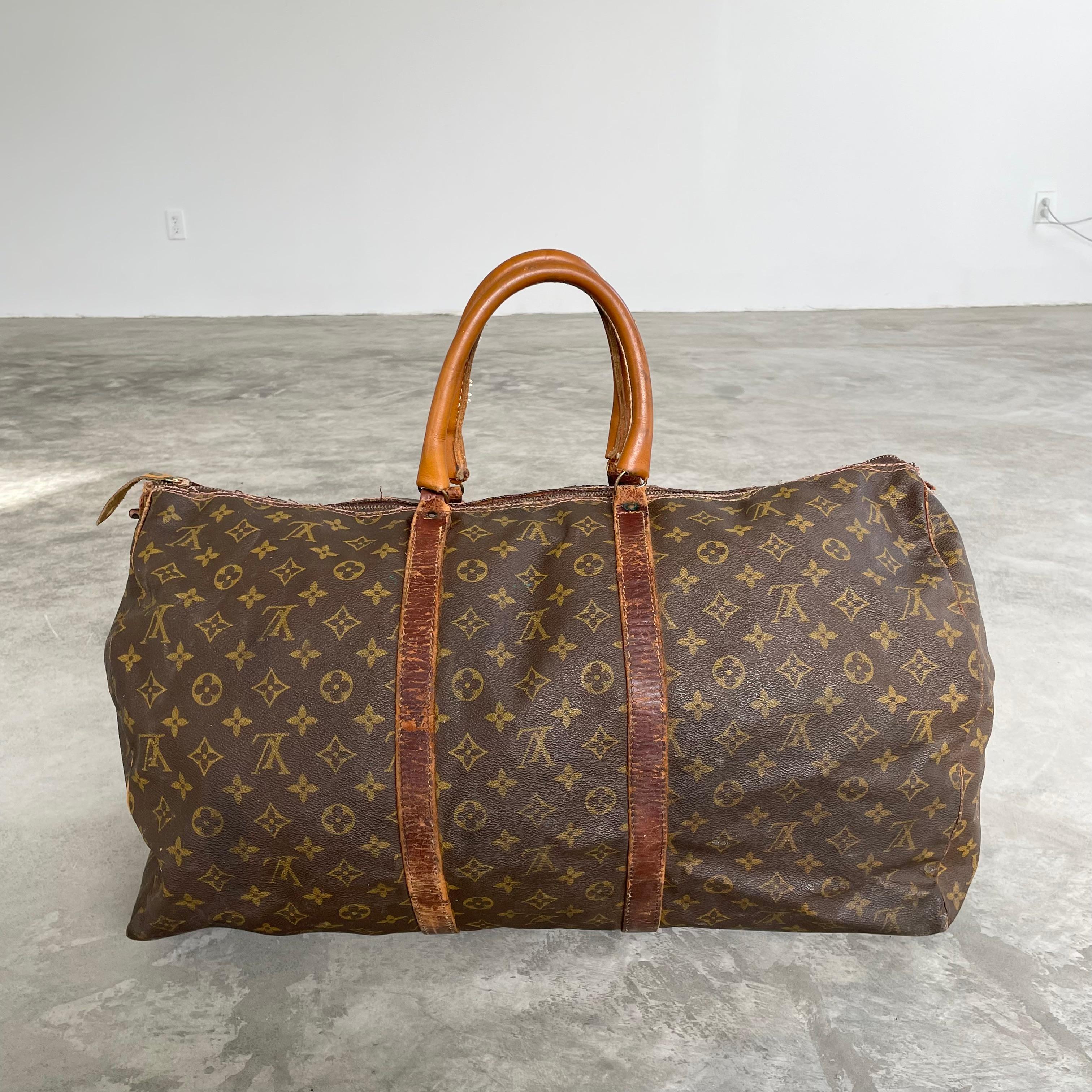 Classic vintage Louis Vuitton duffle bag. Perfect for weekend trips, this LV monogram print duffle is made with saddle leather and brass hardware and wrapped in the iconic Louis Vuitton canvas. Timeless simplicity in design and iconic badging have