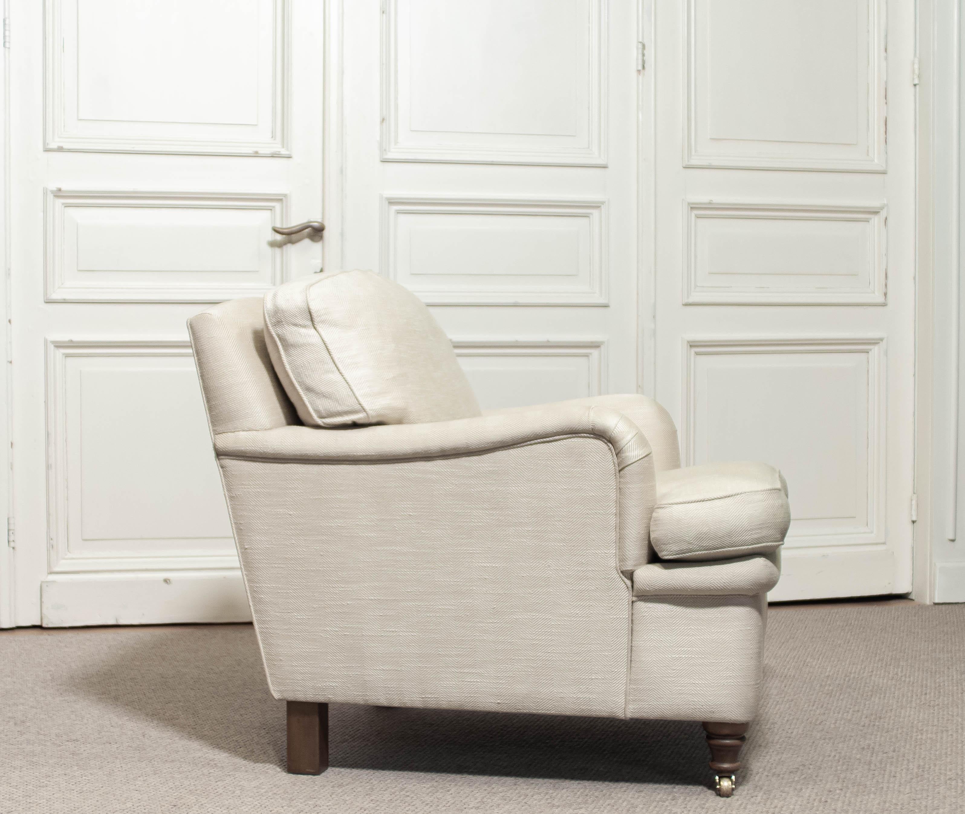 Thiele Holland is delighted to offer a luxurious lounge armchair upholstered in a cream-white wool fabric with a subtle herringbone pattern. Produced by O.H. Sjögren in the second half of the 20th century, this piece is crafted in the refined style
