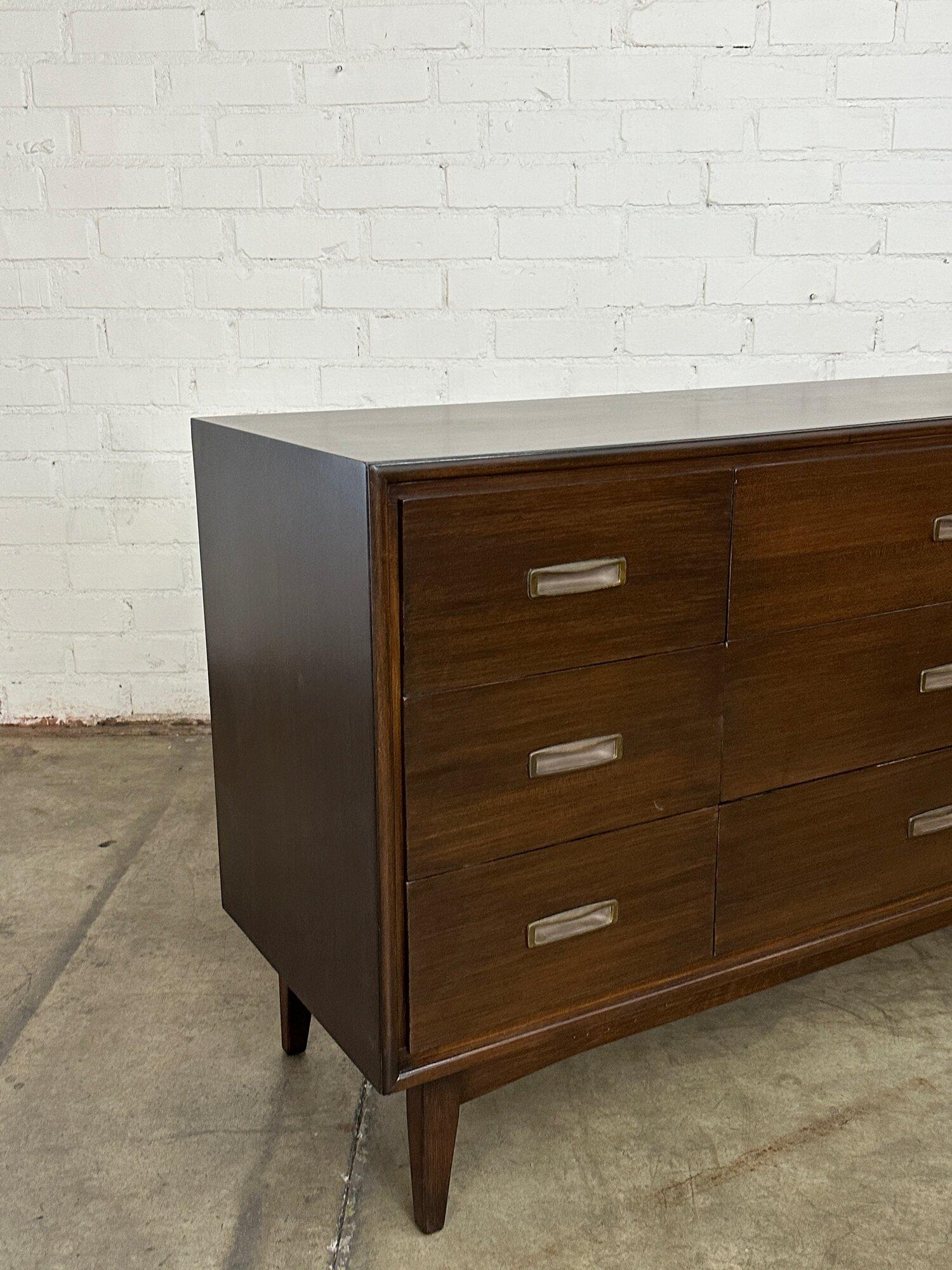 W62 D19 H33

Fully restored dark walnut mid century dresser. Item features original recessed hardware, a rich dark stain, and slightly tapered legs. Item is structurally sound and strudy with no areas of major wear.

