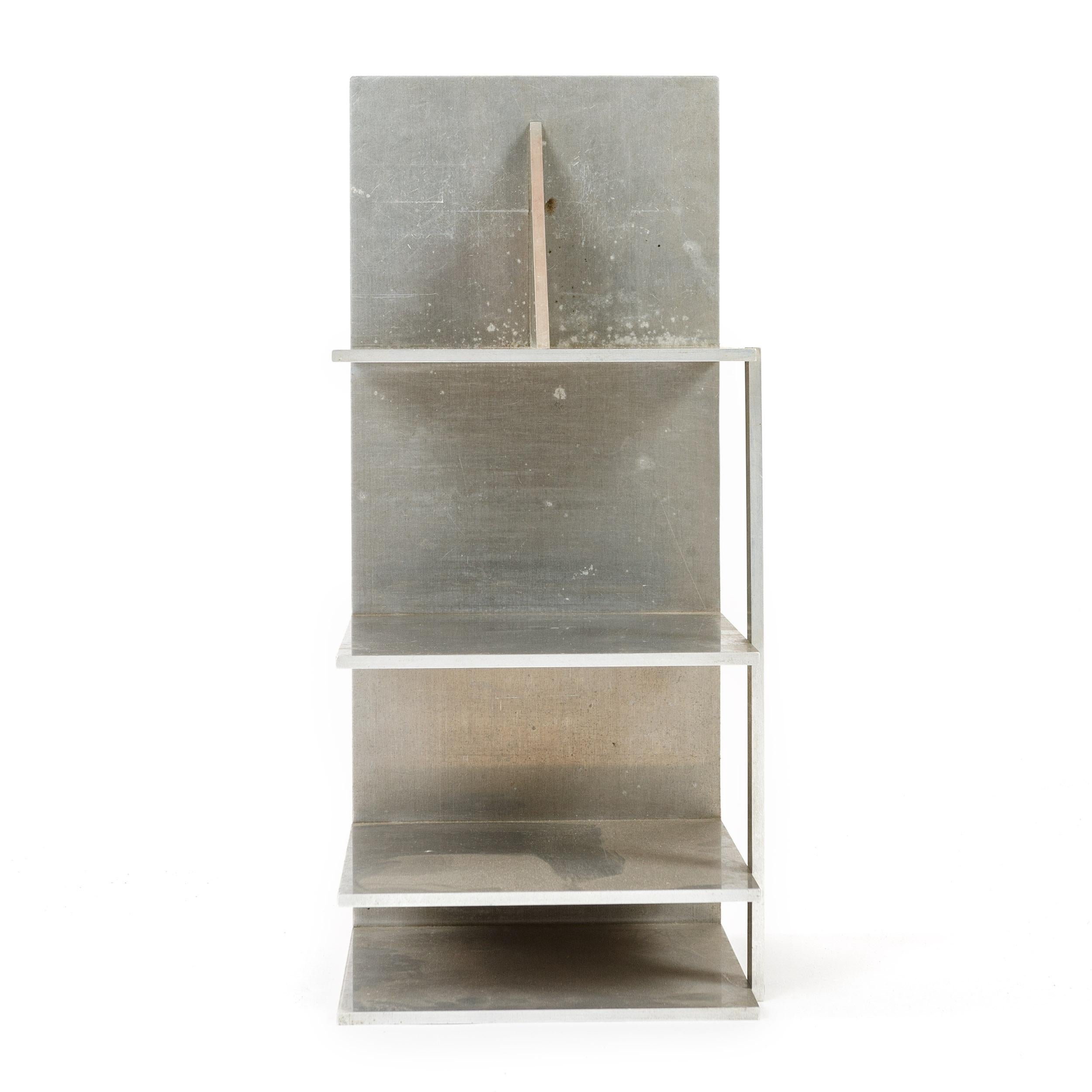 Aesthetically interesting unique and finely crafted open storage unit in machined aluminum. Likely intended for personal use by the individual who crafted it.
  