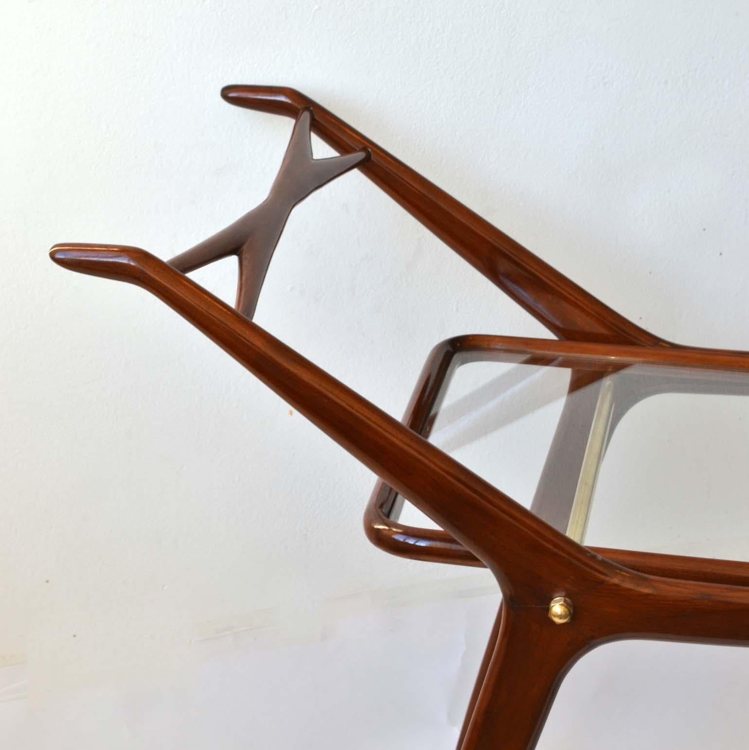 Cocktail hour barware trolley, perfect for the festive season. Elegant mahogany frame and two level glass shelves, Italy, 1950s.
The frame is recently French polished and the glass shelves have been replaced with new toughened glass.
The service