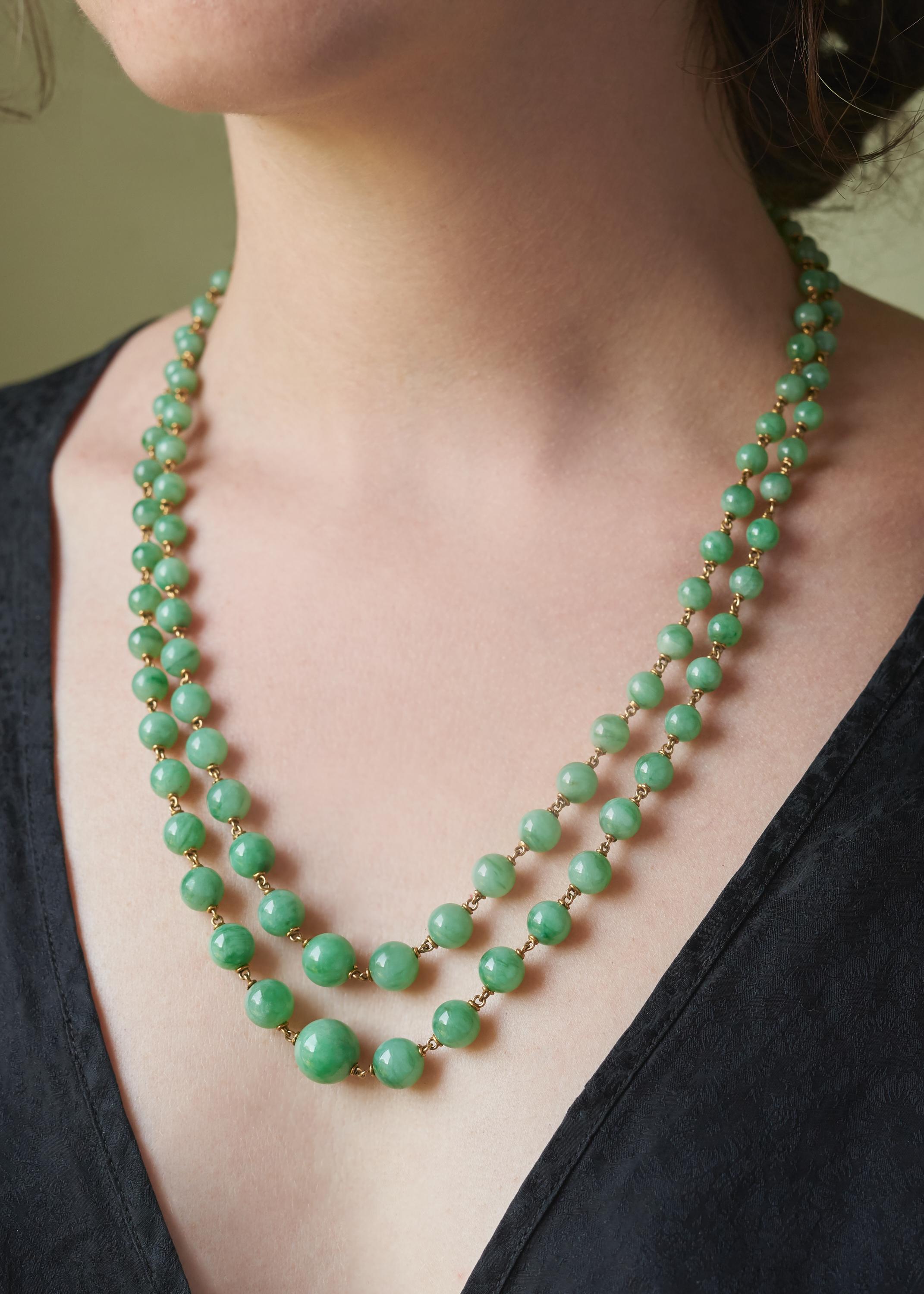 A jade bead and 18 karat gold double strand necklace, by Mario Buccellati, 1950s. Composed of 2 strands of graduated jade beads which terminate in a gold foliate clasp with jade cabochon.

Clasp signed M Buccellati and stamped 750. Shorter strand