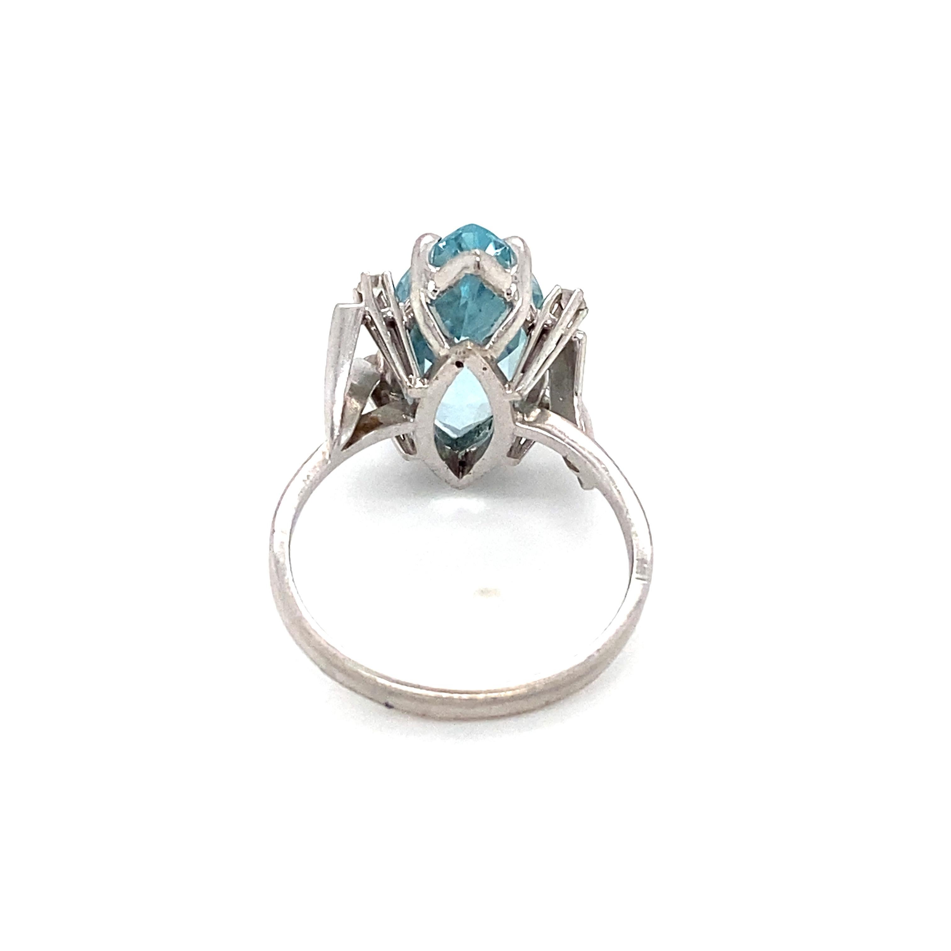 Item Details: This retro ring has a stunning blue aquamarine and shining accent diamonds.

Circa: 1950s
Metal Type: 18 Karat White Gold 
Weight: 5.3 Grams
Size: US 7.5

Diamond Details:

Carat: 0.08 carat total weight
Shape: Round
Color: G 
Clarity: