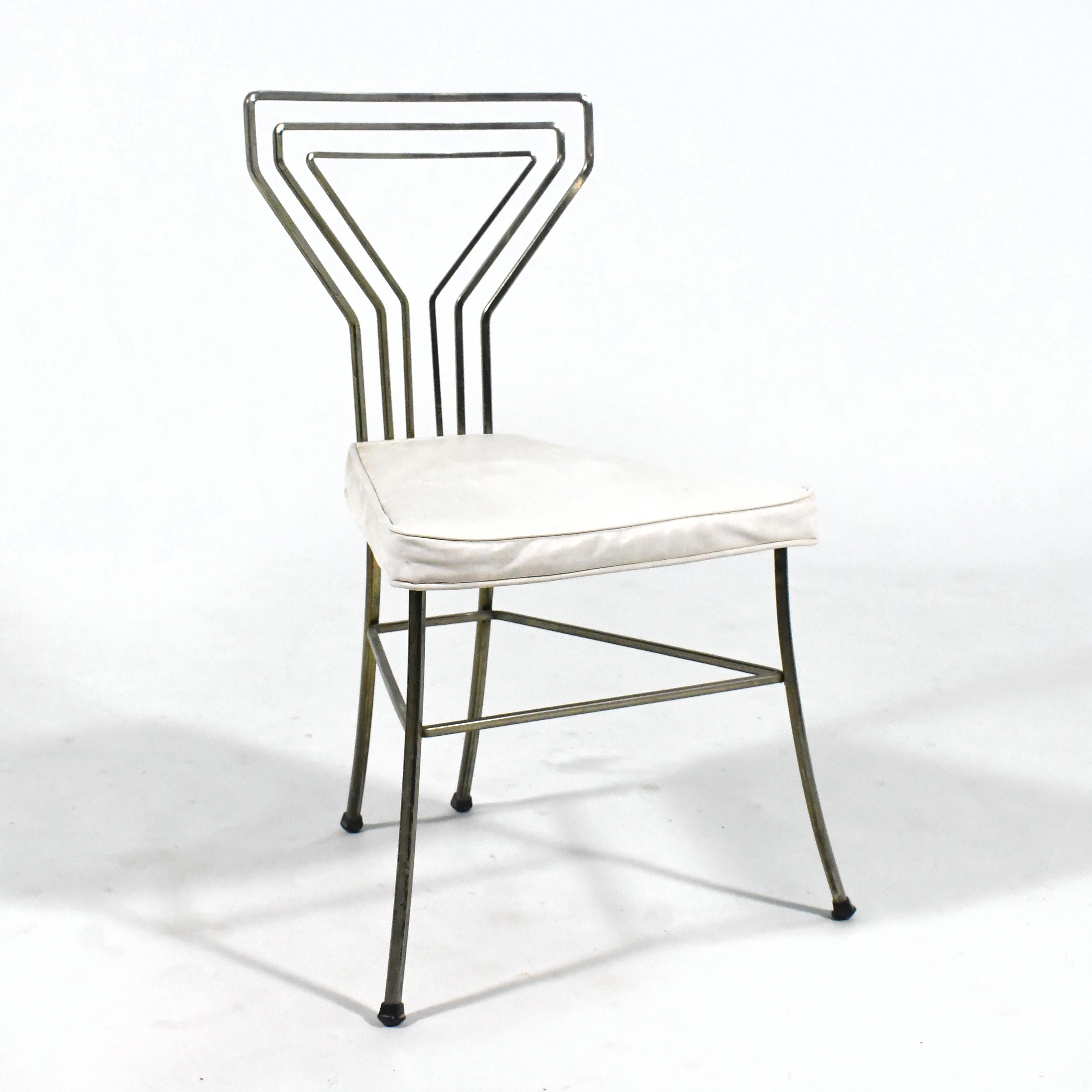 A visually light and lovely design from the 1950s, this side chair has a back with a pattern in bent square stock that echos the shape of a martini glass.

31.55