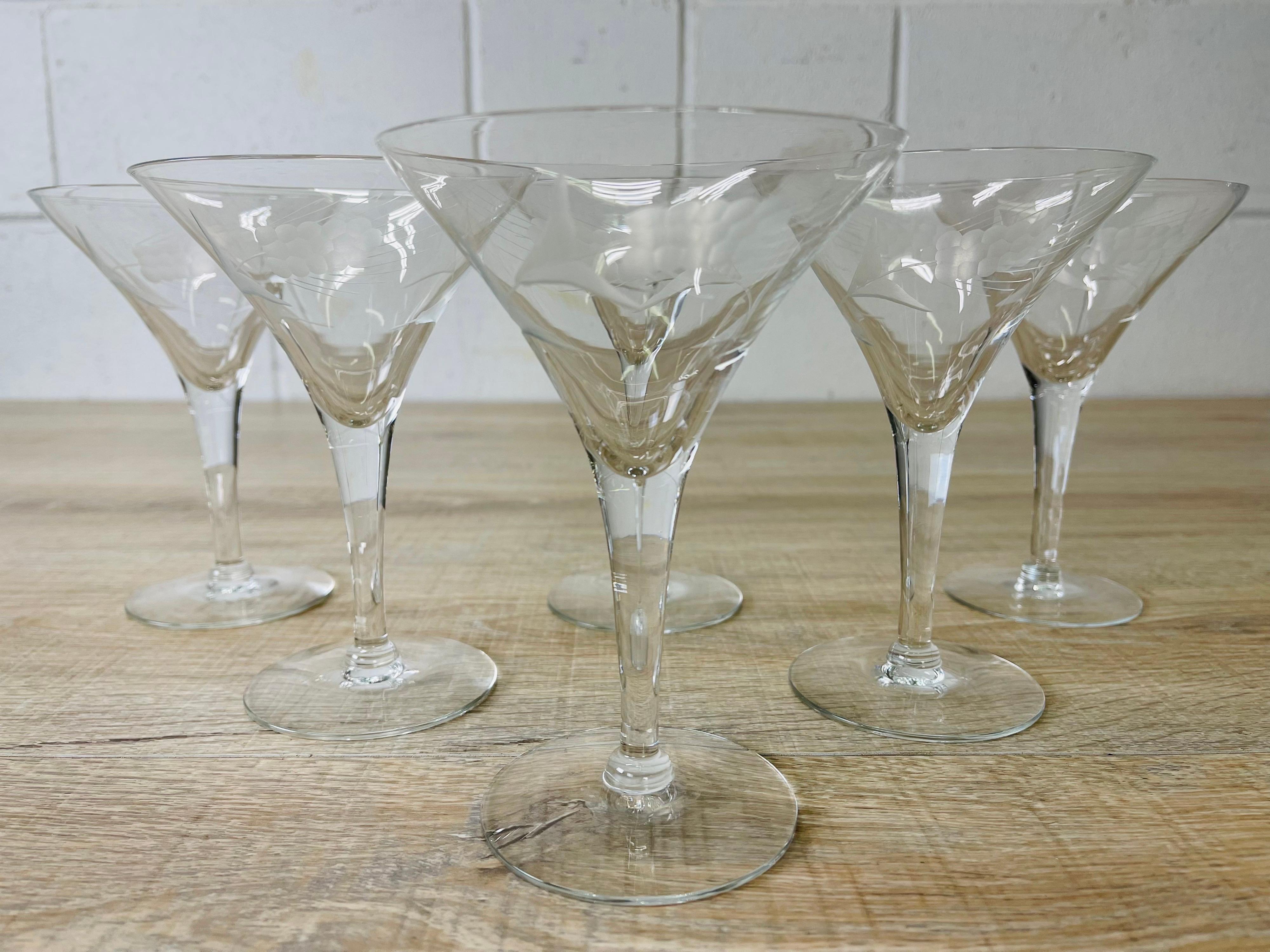 Vintage 1950s set of 6 clear glass martini stems with a grape design. No marks.