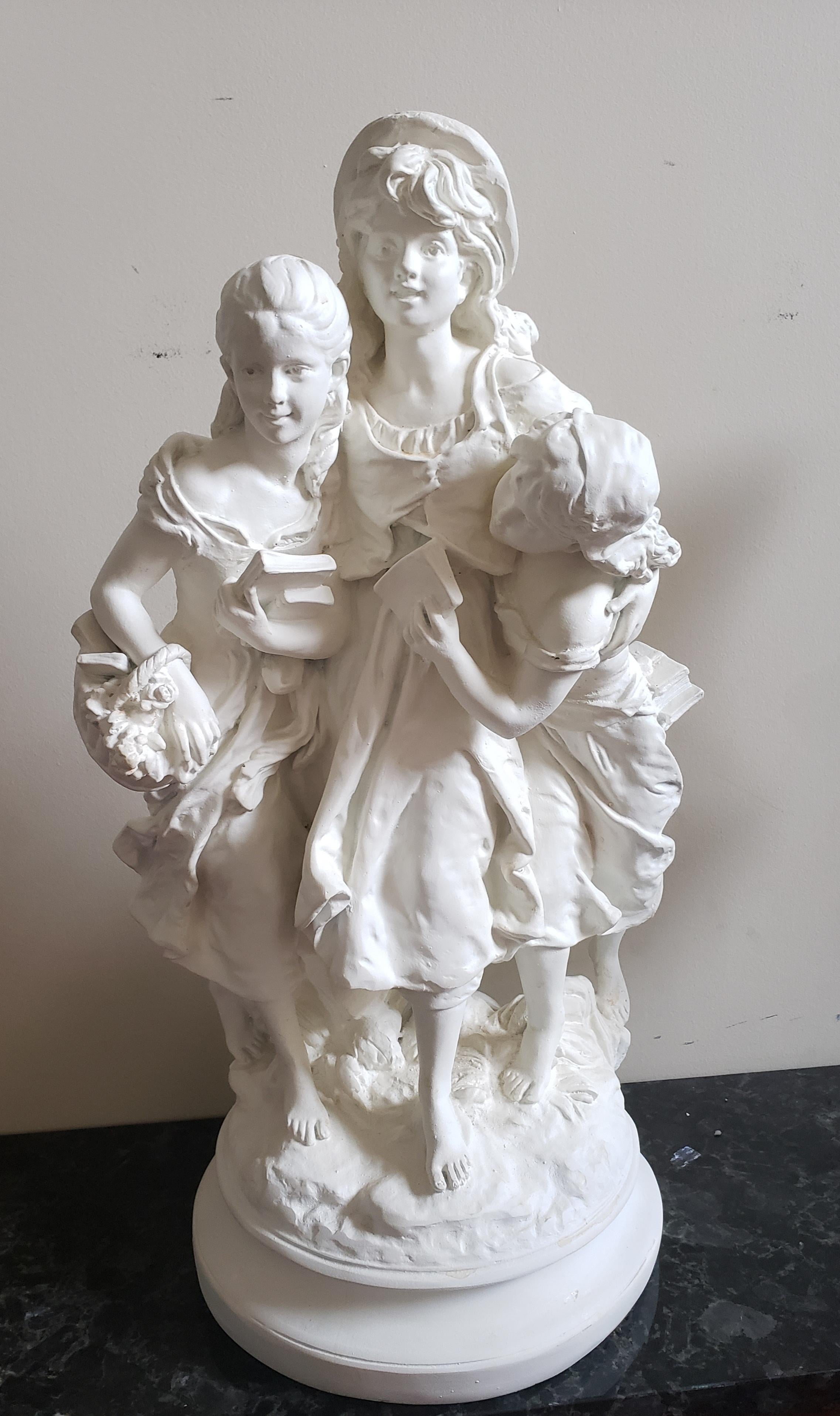 Marwal Ind. Inc plaster figural plaster sculpture depicting a maiden with her two children holding books. An inspirational piece for children and mothers. Very clean vintage condition in antique white color. 
Measures 12 inches in base diameter and