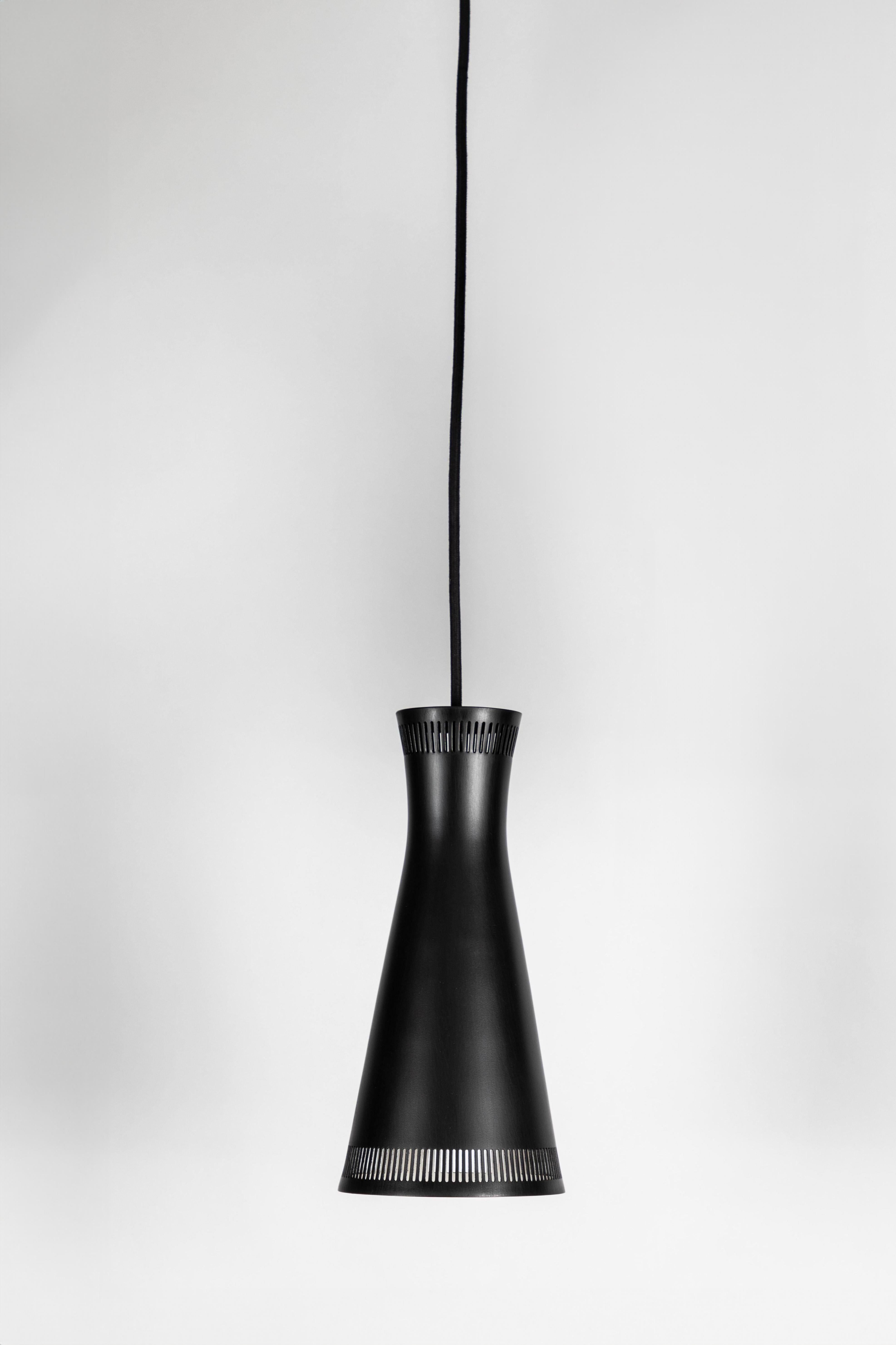 1950s Mauri Almari Perforated Black Metal Pendant for Idman Oy Finland. A rare example executed in black painted and perforated metal with period-style brass canopy for mounting over standard US j-box. Highly reminiscent of Paavo Tynell's iconic