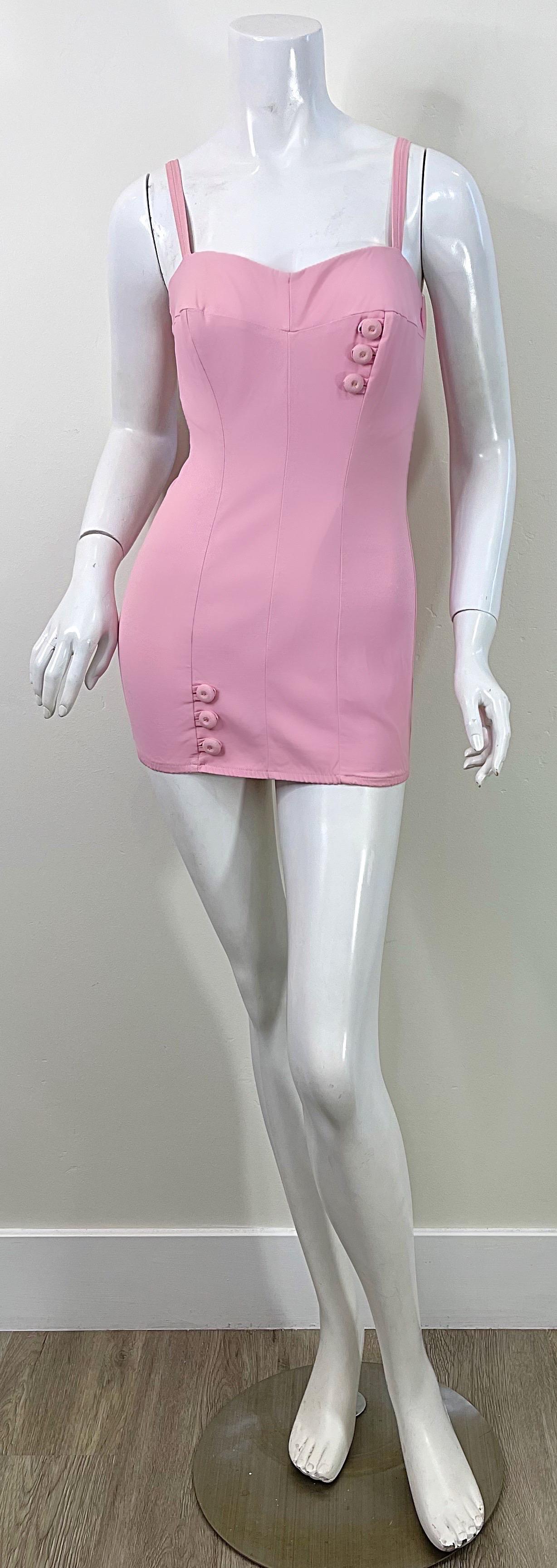 Amazing and rare 1950s MAURICE HANDLER bubblegum pink one piece swimsuit ! Channel your inner Barbie in this museum worthy frock. Features mock buttons at left bust and right leg. Full metal zipper up the back with hook-and-eye closure. 
Perfect for