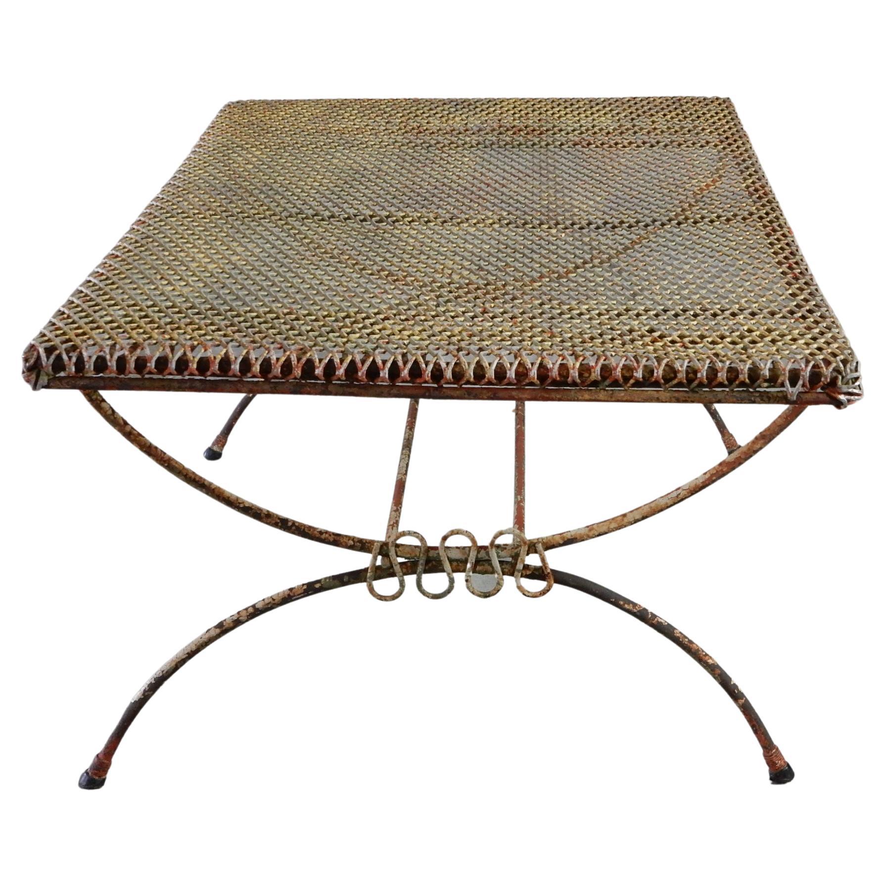 1950's Iron ribbon cocktail table attributed to Maurizio Tempestini.
Heavy steel mesh top with iron rod frame.
Several colors or paint and aged patina make this a 
wonderful unique piece for your outside patio.