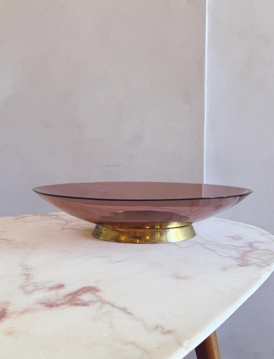 Uno spettacolare centrotavola in vetro rosa di grandi dimensioni progettato negli anni '50 da Max Ingrand per Fontana Arte, l'iconica vetreria milanese. Questa splendida ciotola in vetro curvato si trova in cima a un grande anello di ottone. Un