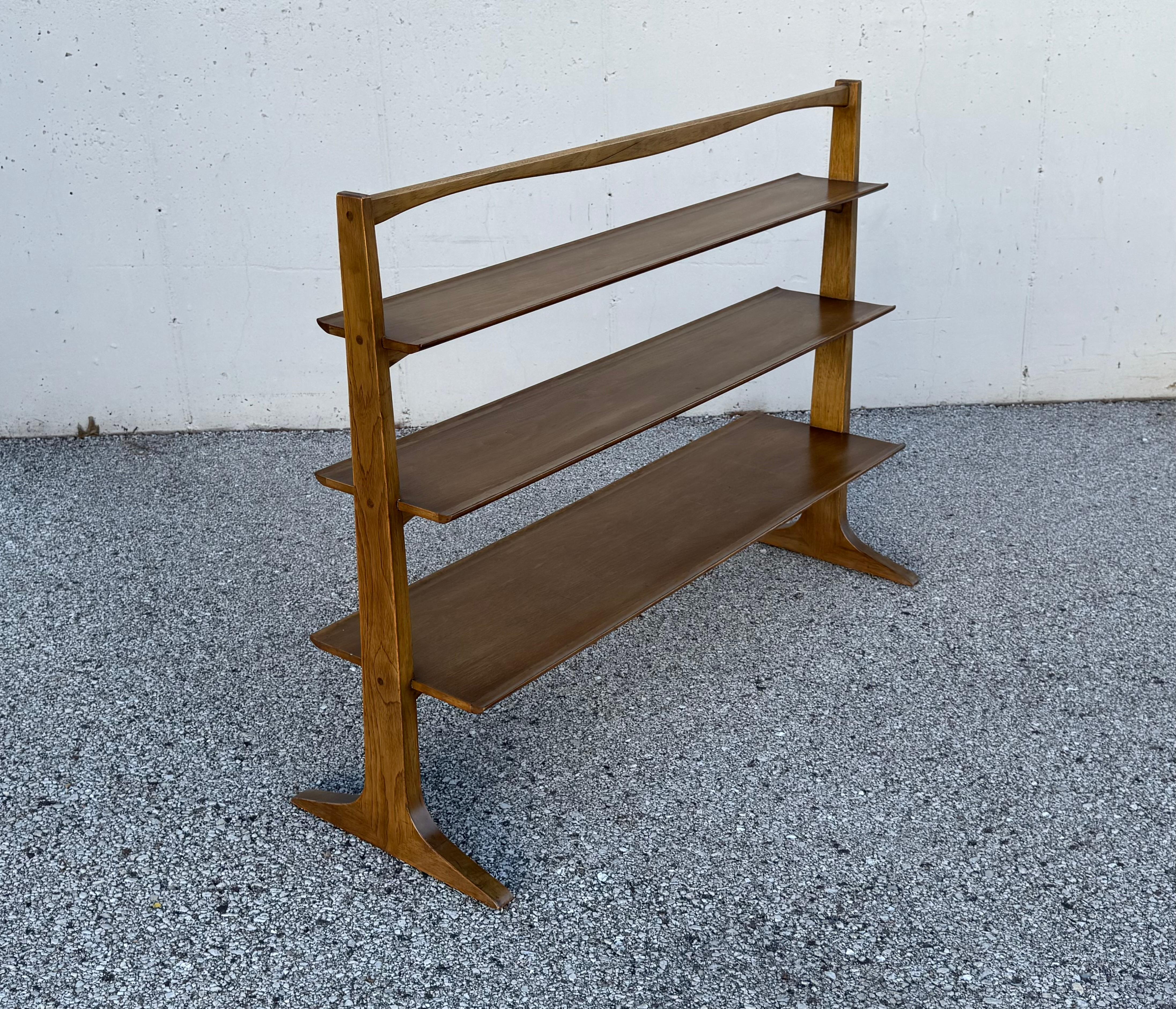 Mid-Century Modern freestanding sculptural pyramid form bookshelf or room divider designed by John Van Koert for Drexel and manufactured in 1956.  The walnut frame and shelves, retain the original finish, some wear to shelves, otherwise structurally