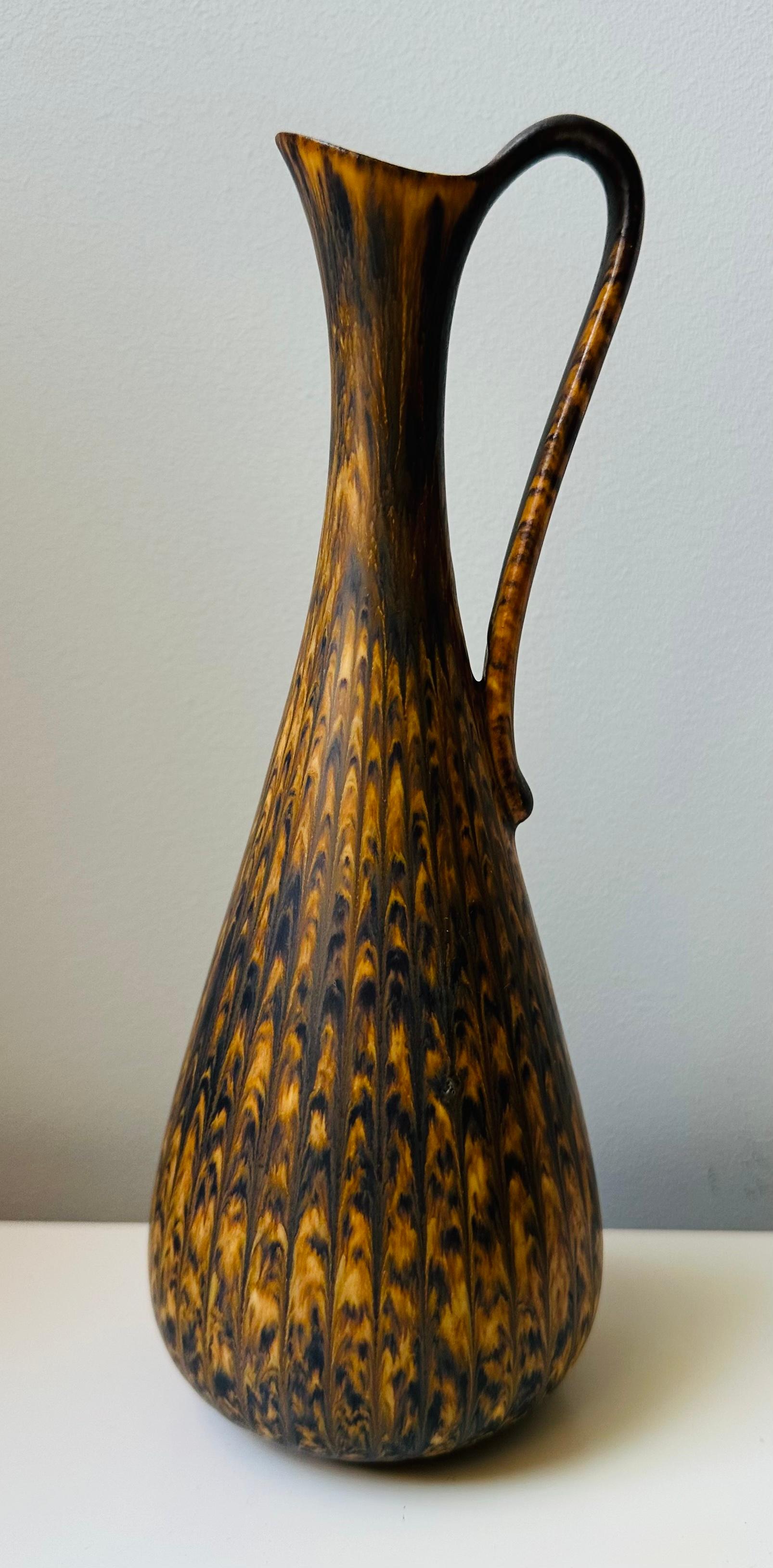 A beautifully marbled 1950s Swedish handle-jug designed by Gunner Nylund for the Rörstrand Factory.  The pottery, stoneware jug features a wonderful smooth glaze in marble effect tones of browns and golden-brown colours.  Inscribed on the base: 