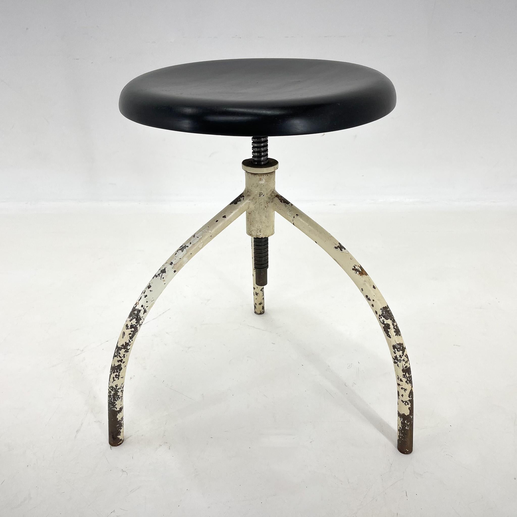Vintage medical stool made of iron and wood. The hight is adjustable with 57 cm of the maximum hight. The wooden seat was refurbished and it's diametr is 33 cm.