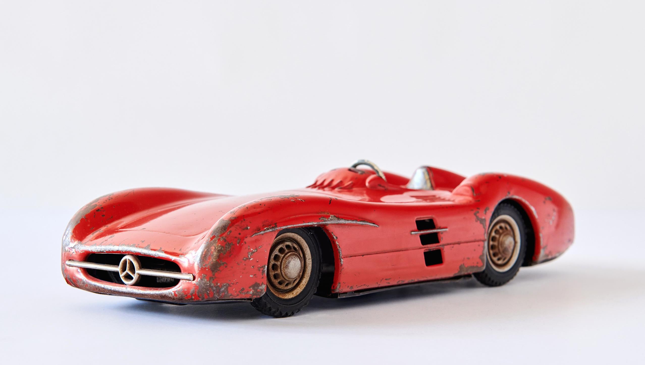 This beautiful 1950s metal toy car is an accurately modeled representation of the technological tour-de-force Mercedes-Benz W196 racing car, a masterpiece of streamlining. It was made by JNF -- Johann Neuhierl Fürth -- in the 1950s. Much played with