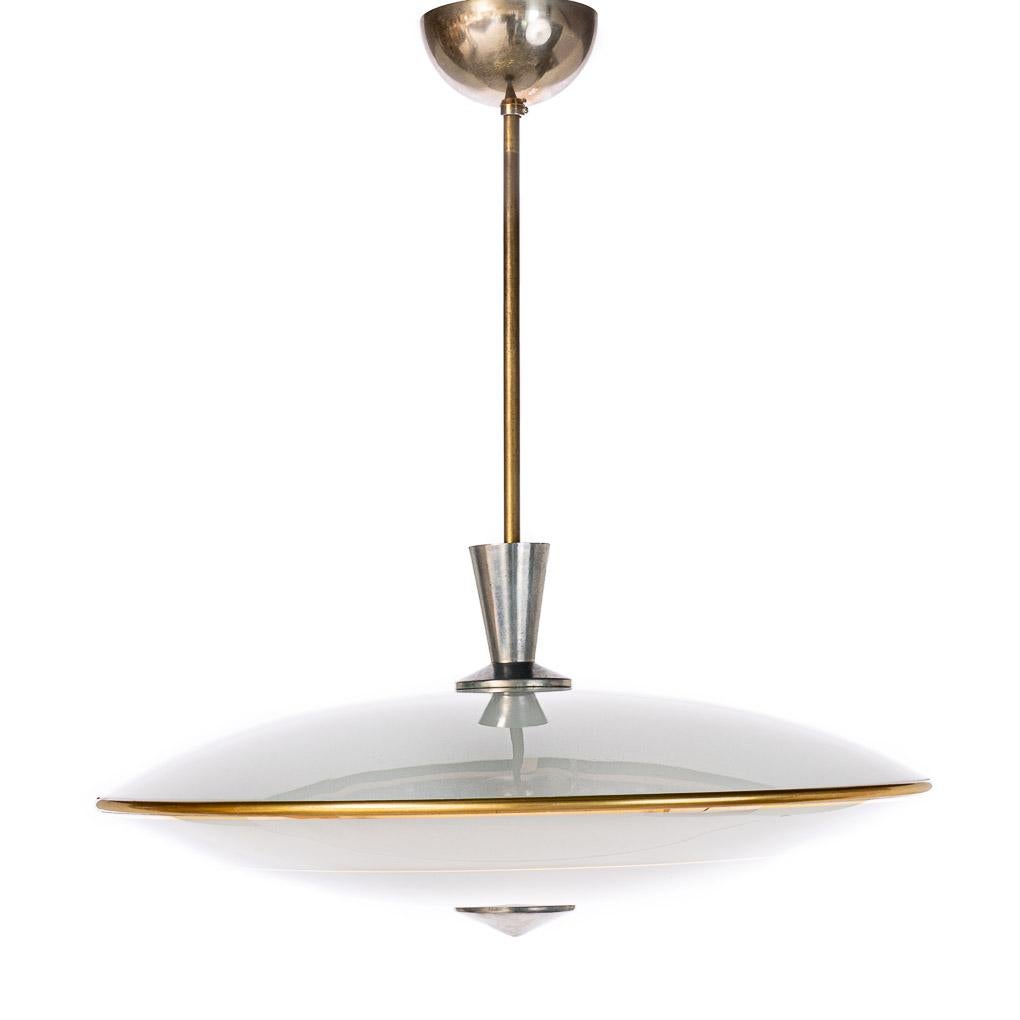 This elegant piece consisting of a brass and metal frame and 2 unique frosted and satin glass reflector/saucers. 
The lower round curved glass reflector with 2 gold colored rings mounts below a round satin glass reflector. Finished off with a brass