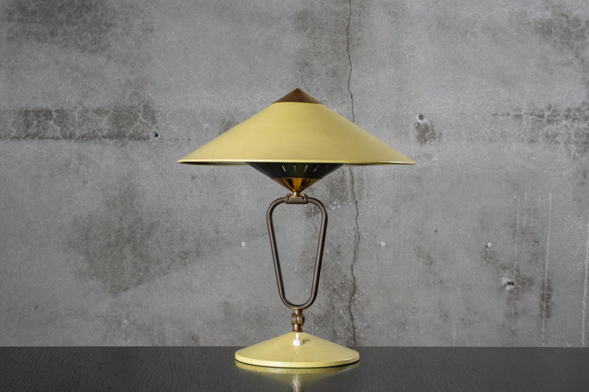 Swivel table lamp with a yellow metal shade, from the 1950s.