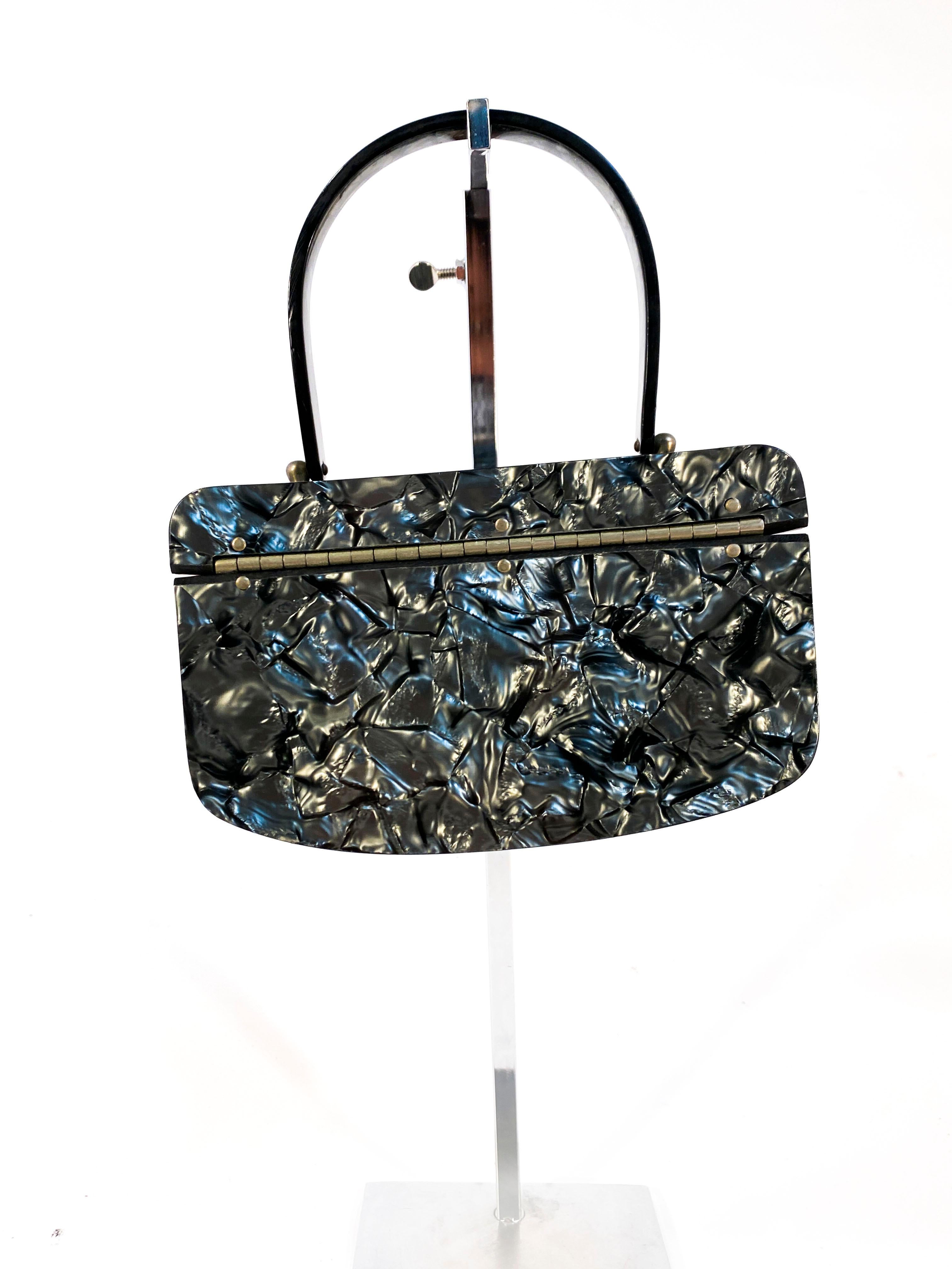 1950s Metallic Multi-Grey Iridescent Lucite Purse wit a marbleized pattern, pewter closure, and a single matching handle.