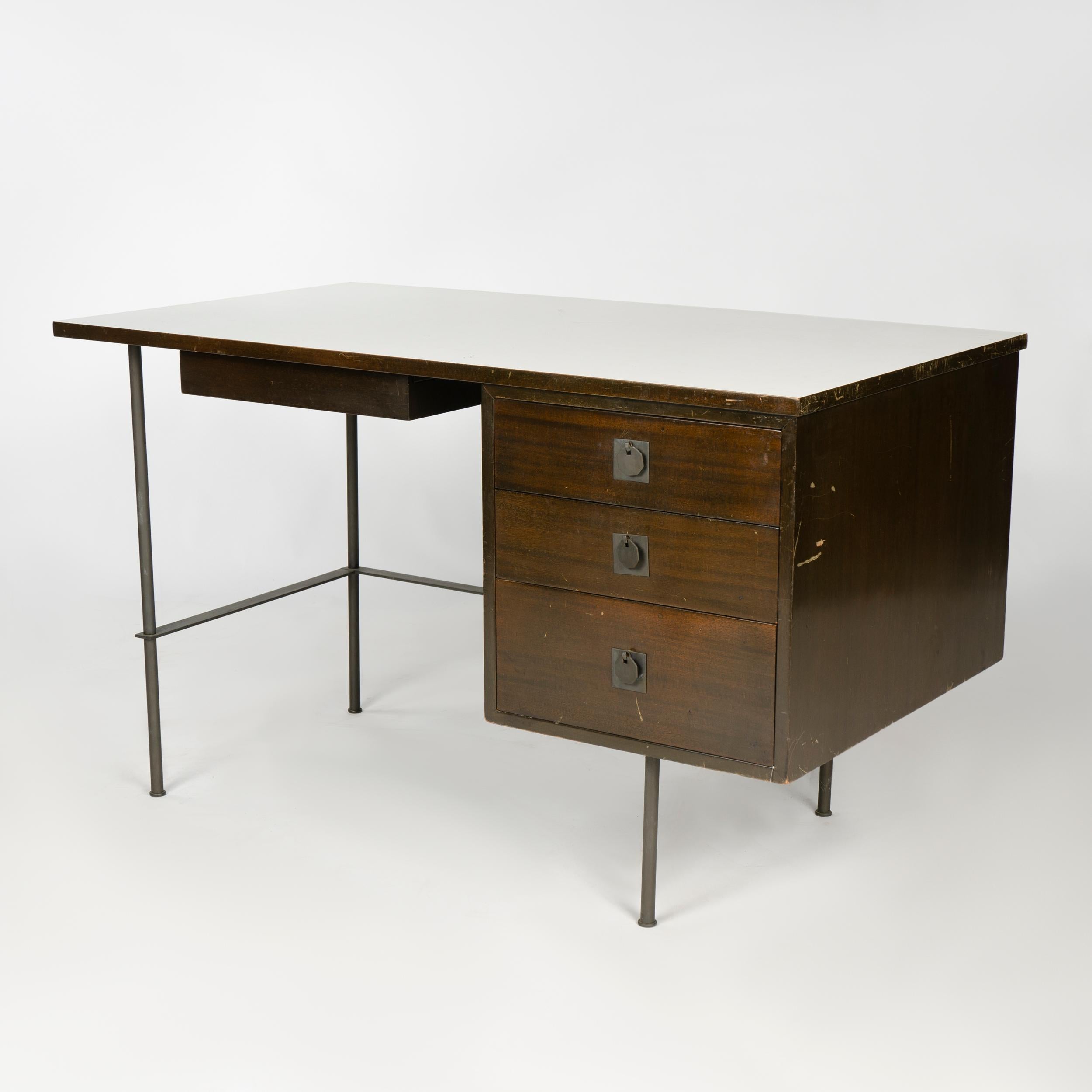 A four-drawer mahogany metaphor desk with solid brass legs and white laminate top. Priced as-is.