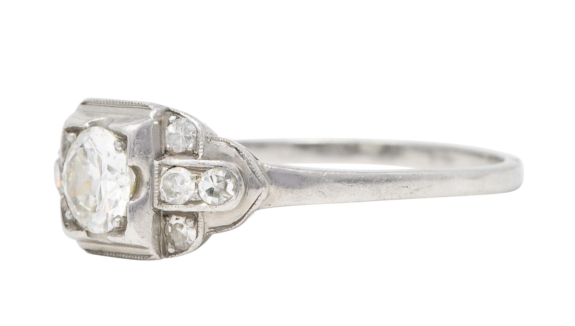 Centering a transitional cut diamond weighing approximately 0.45 carat - H/I with VS clarity

Set low in a square form head in an East/West mounting designed as a buckle motif

Accented by single cut diamonds weighing in total approximately 0.20