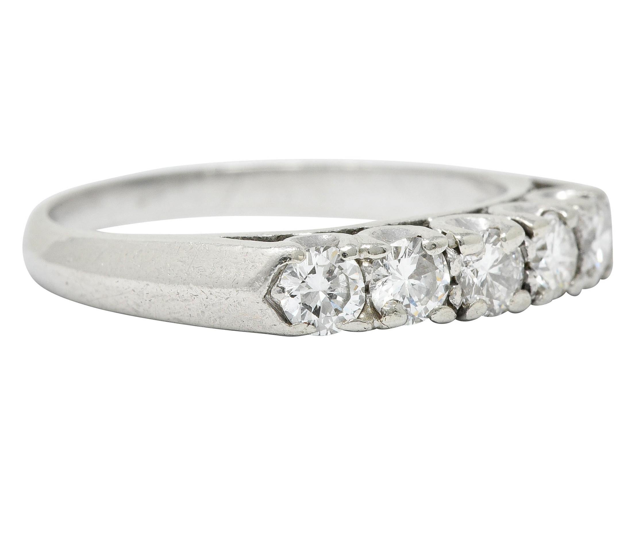 Set to front by five round brilliant cut diamonds

Weighing in total approximately 0.75 carat; G/H color with VS clarity

With a fishtail motif profile and slight cathedral shoulders

Stamped for platinum

Circa: 1950s

Ring Size: 7 1/2 &