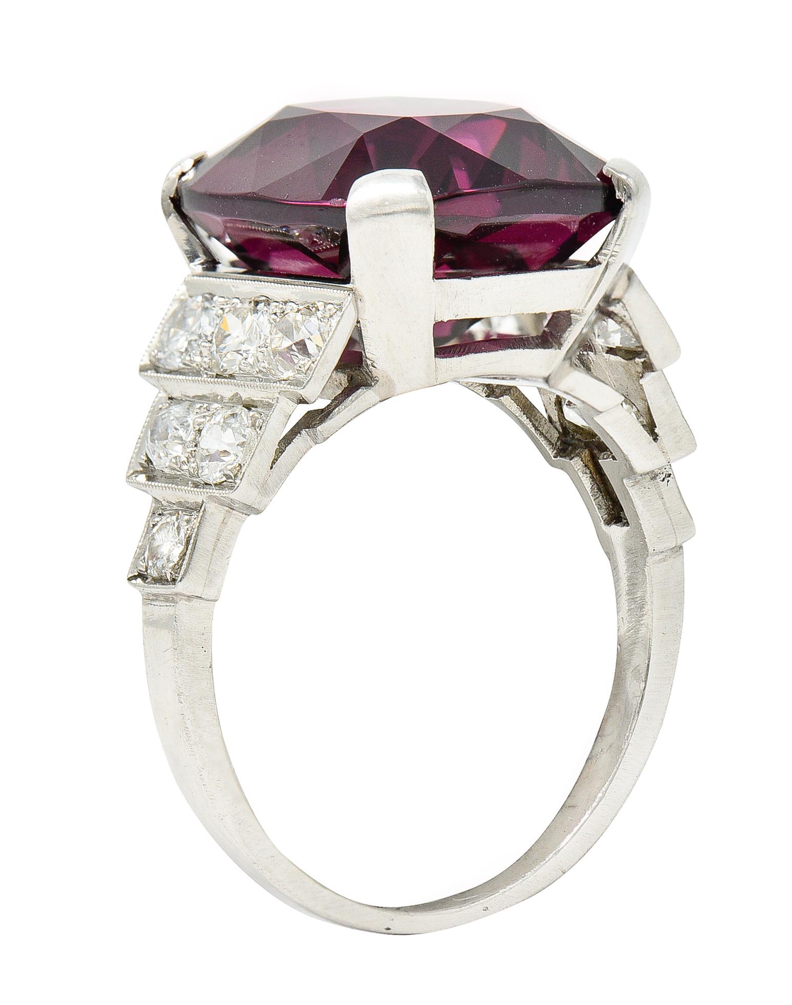Cathedral basket ring centers a substantial cushion cut spinel

Weighing approximately 11.71 carats with saturated medium dark and strongly purplish red color

Flanked by tiered shoulders accented by milgrain details

Set with old European and