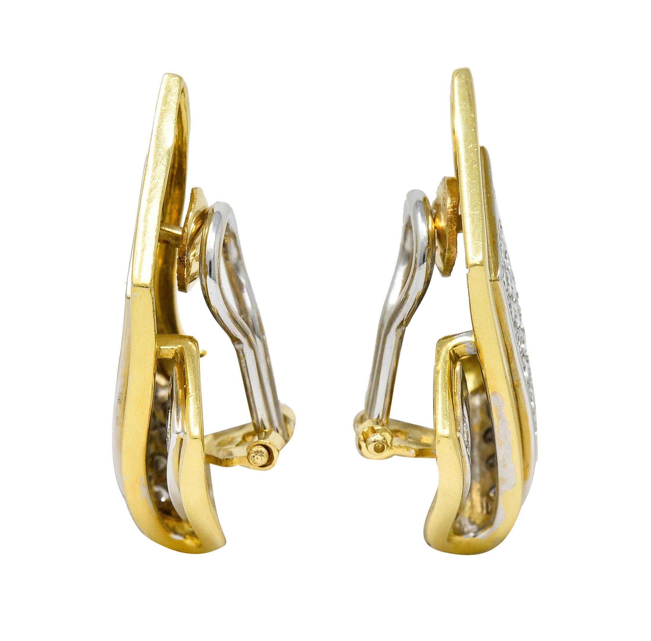 Ear-clips are designed as a folded ribbon motif

Centering round brilliant cut diamonds - pavè set in white gold with a polished yellow gold surround

Weighing in total approximately 2.50 carats with G/H color and VS to SI clarity

Completed by