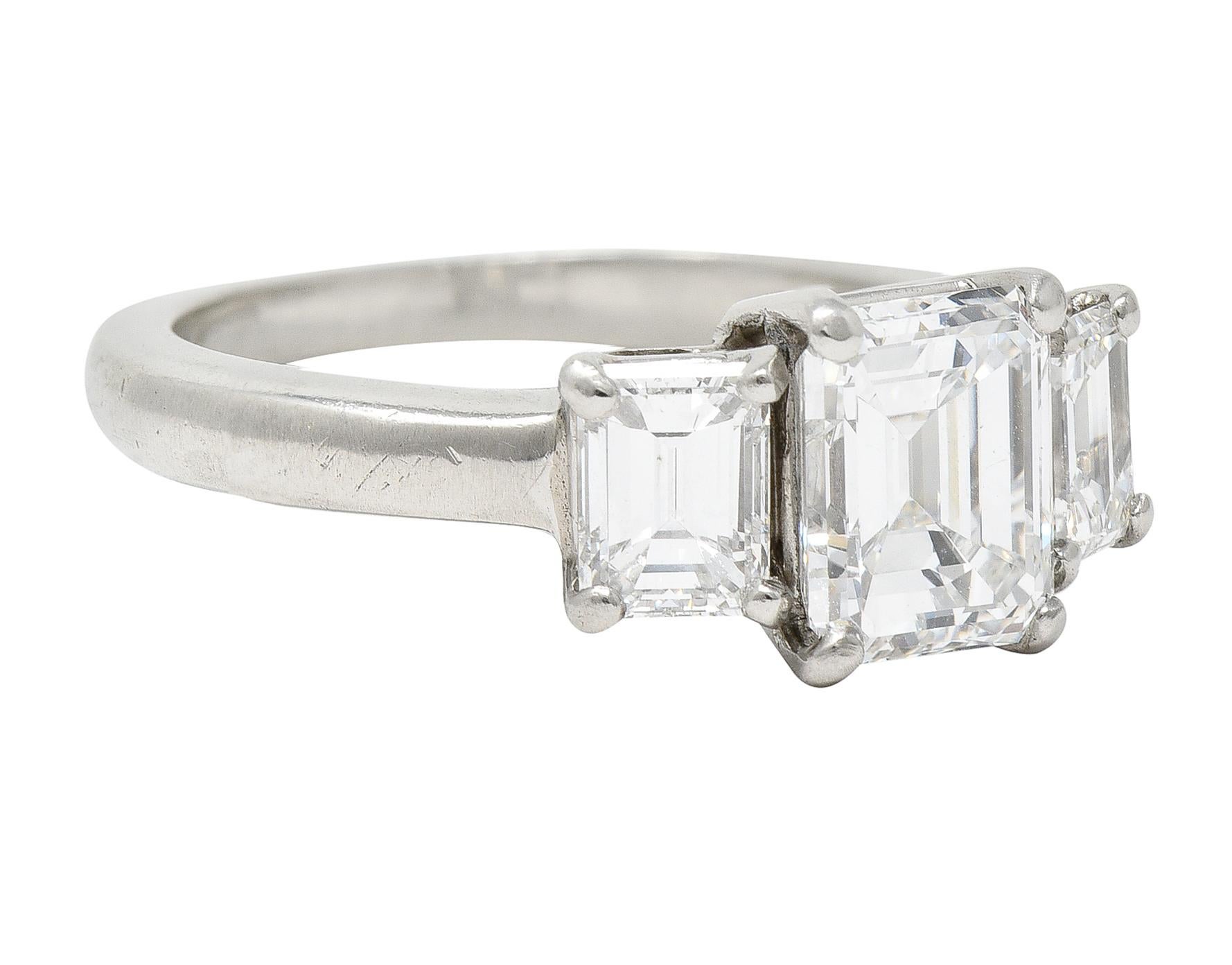 Featuring three basket set emerald cut diamonds. Center weighs 1.53 carats with E color and VS2 clarity. Remaining weigh collectively approximately 0.98 carat with E/F color and VS clarity. Stamped for platinum. With maker's mark. Circa: 1950s. Ring