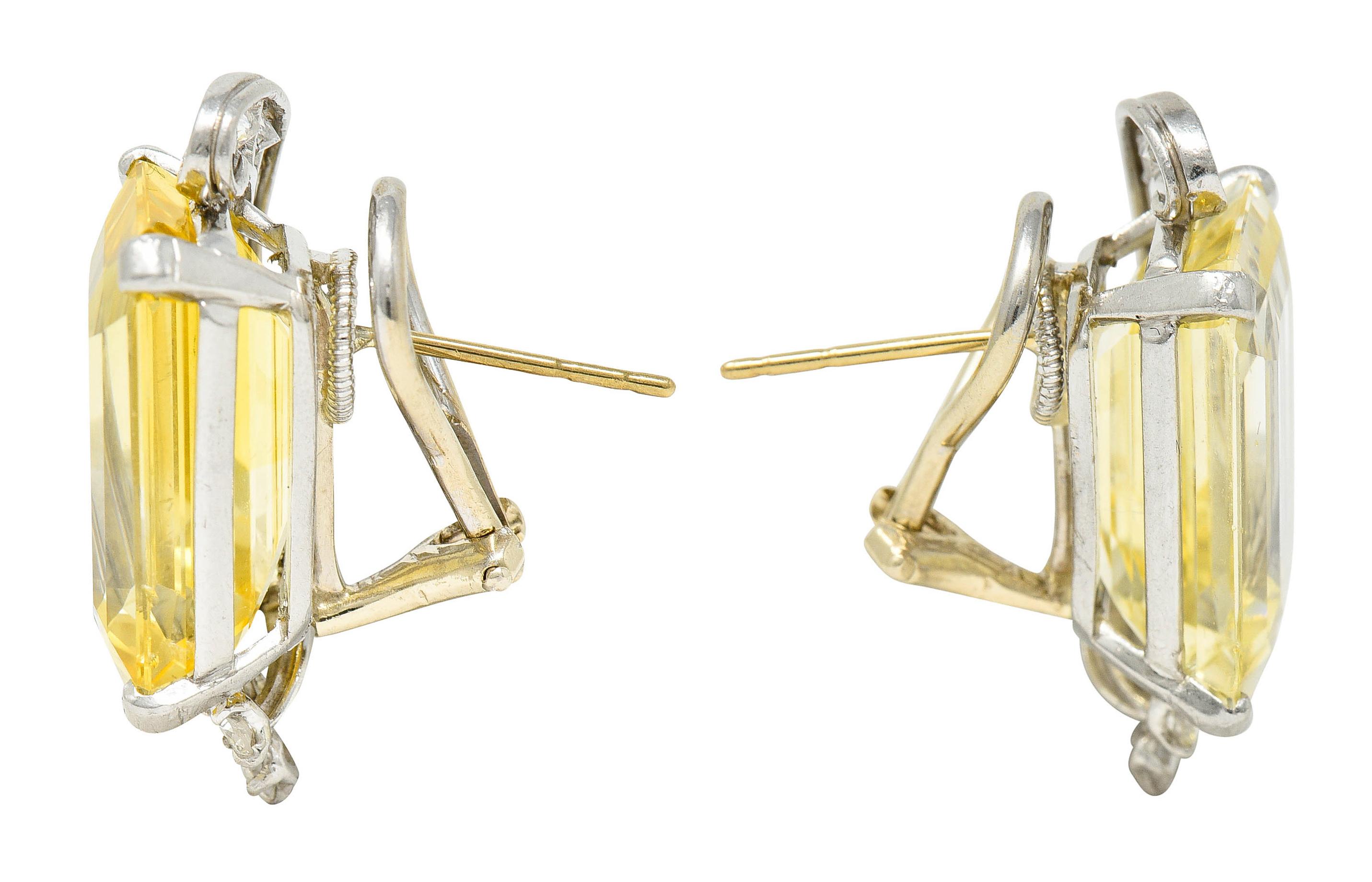 Earrings feature emerald cut yellow sapphires weighing in total approximately 27.50 carats

Very well matched in medium light color and very eye clean with one minor surface reaching inclusion

Basket set by wide prongs with a sweeping platinum