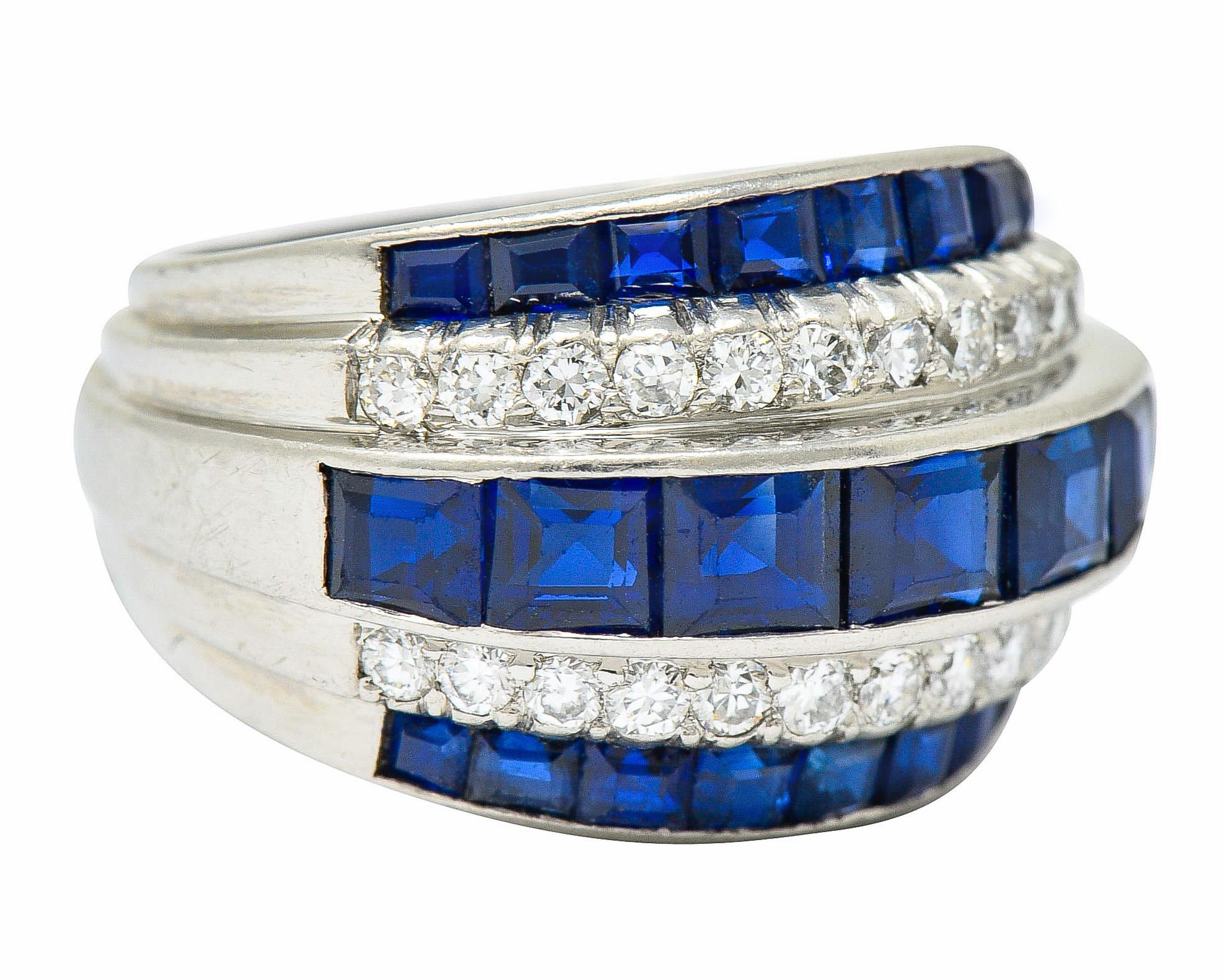 Wide band ring is comprised of five rows of sapphires and diamonds, alternating

Square cut sapphires are a very well-matched medium-dark blue and weigh in total approximately 3.25 carats

Round brilliant cut diamonds weigh in total approximately
