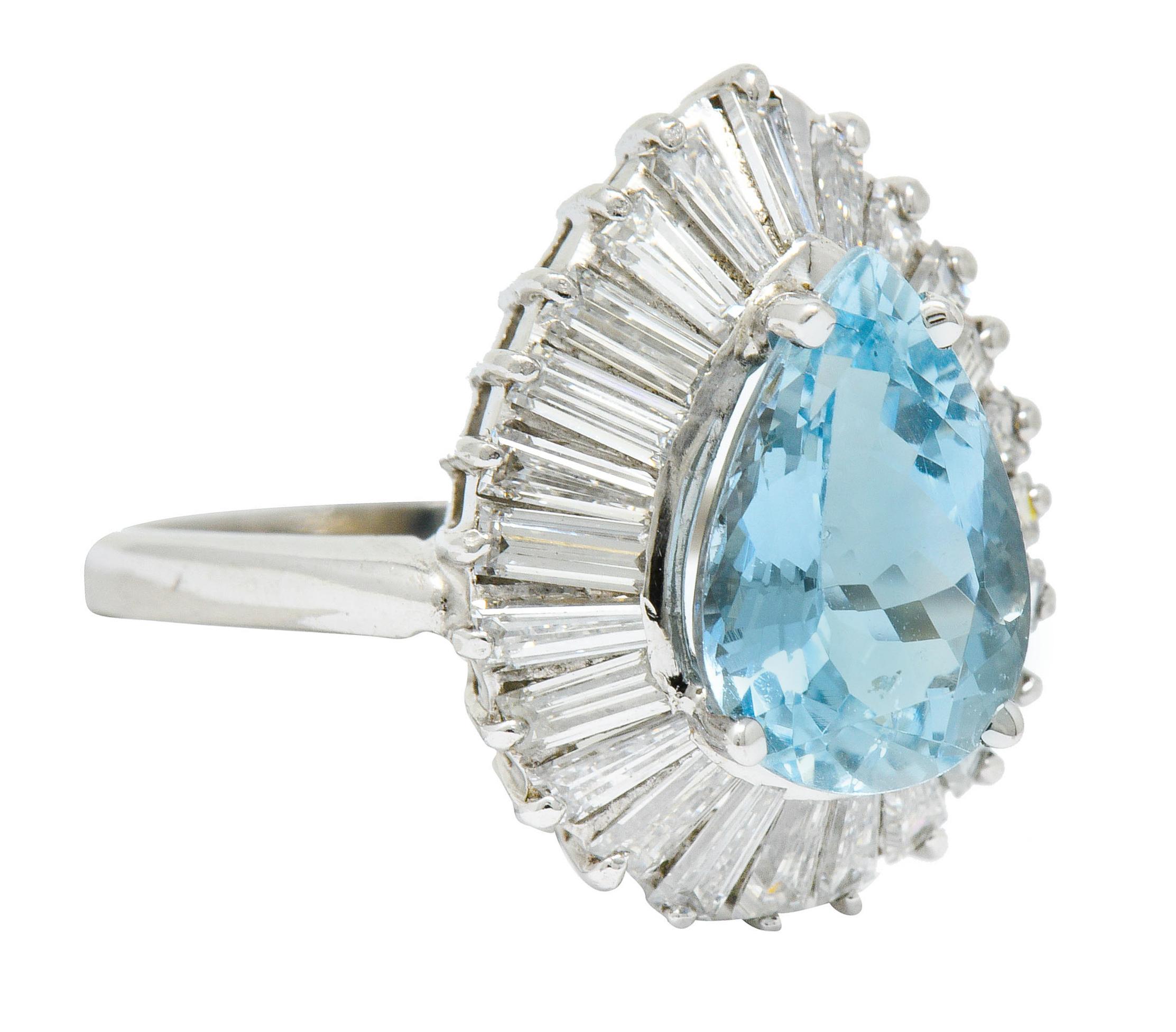 Cluster style ring centers a pear cut aquamarine weighing approximately 2.45 carats - light greenish blue in color

Surrounded by a ballerina style halo of tapered and straight baguette cut diamonds

Weighing in total approximately 2.16 carats with