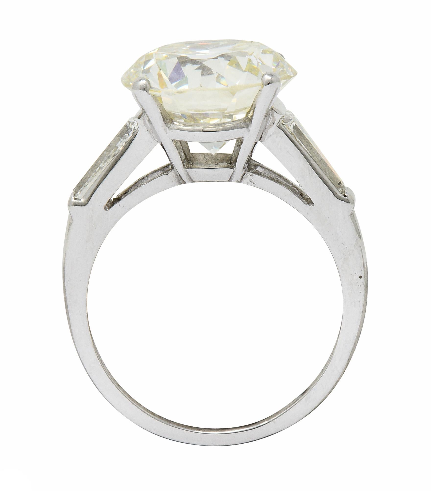 Centering a transitional cut diamond weighing 7.51 carats with O to P color and VVS2 clarity

Basket set and flanked by sleek cathedral shoulders

Bar set with tapered baguette cut diamonds weighing approximately 0.72 carats; L color with VS