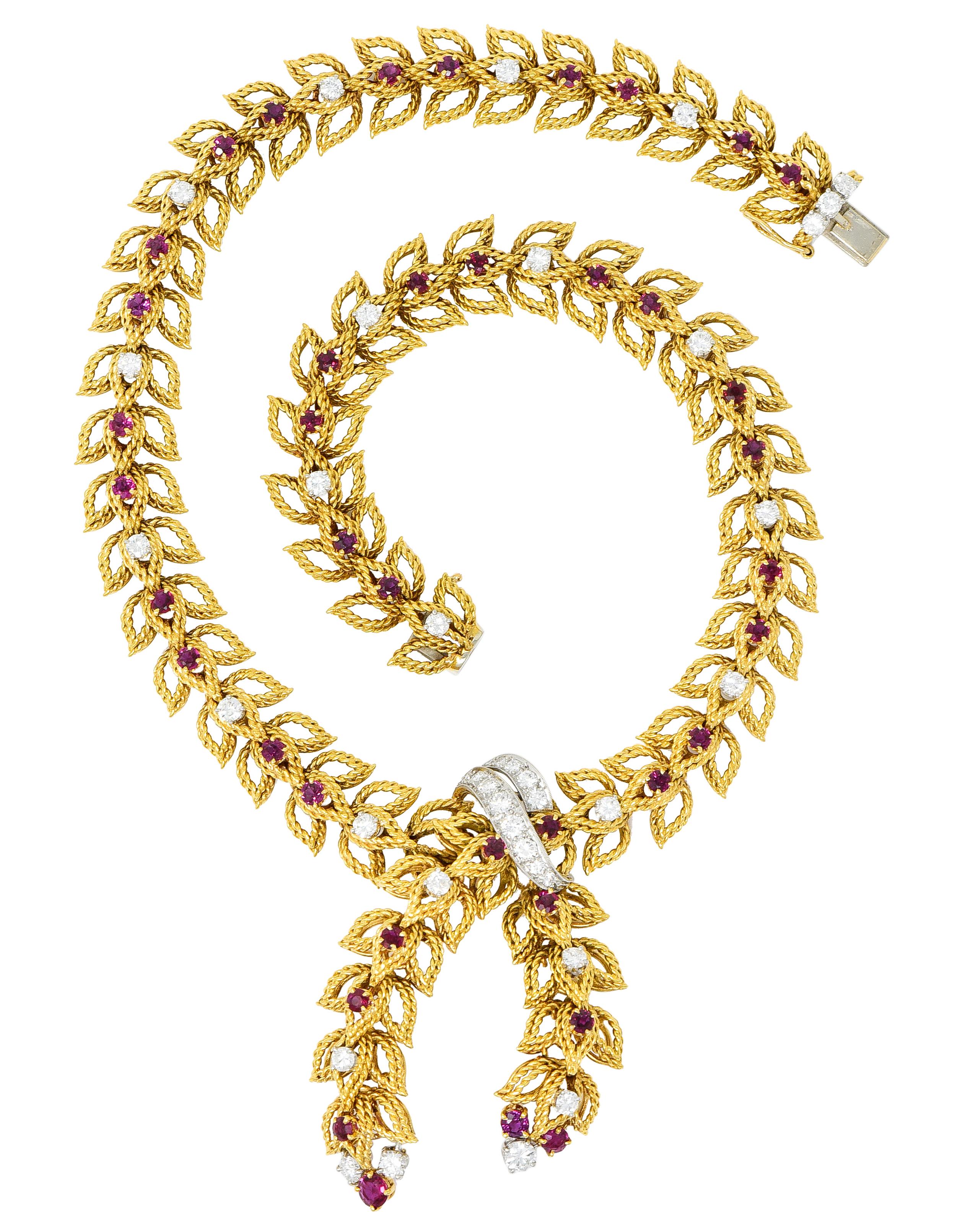 Lariat style collar necklace comprised of foliate links designed as three pointed leaves of twisted gold

Foliate linkage overlaps at center, secured by a sweeping platinum station, as articulated foliate drops

Accented throughout by round cut