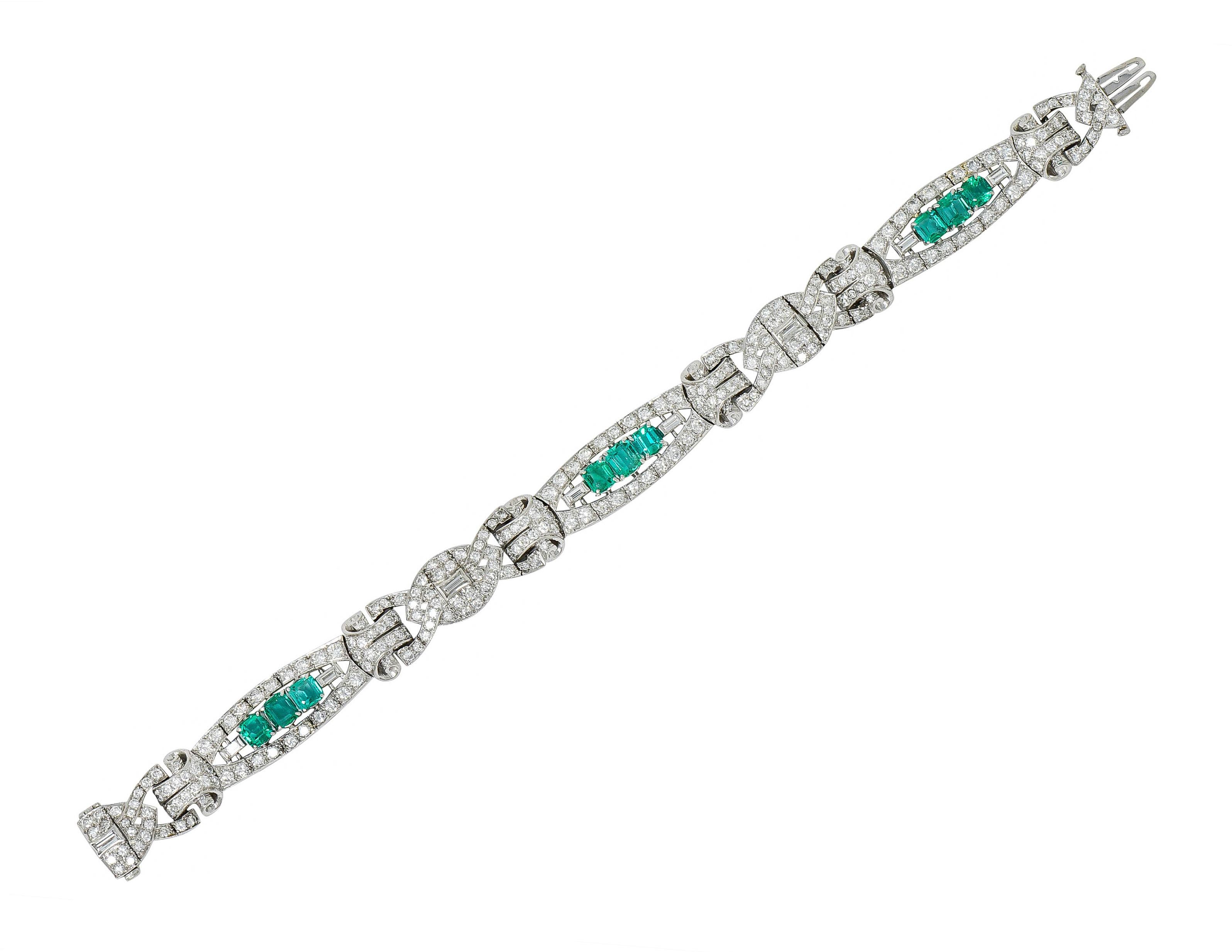 Bracelet is comprised of buckle and elongated links alternating with dynamically scrolled spacer links

Elongated links center triads of cushion and emerald cut emeralds weighing in total approximately 3.30 carats

Remarkably transparent and