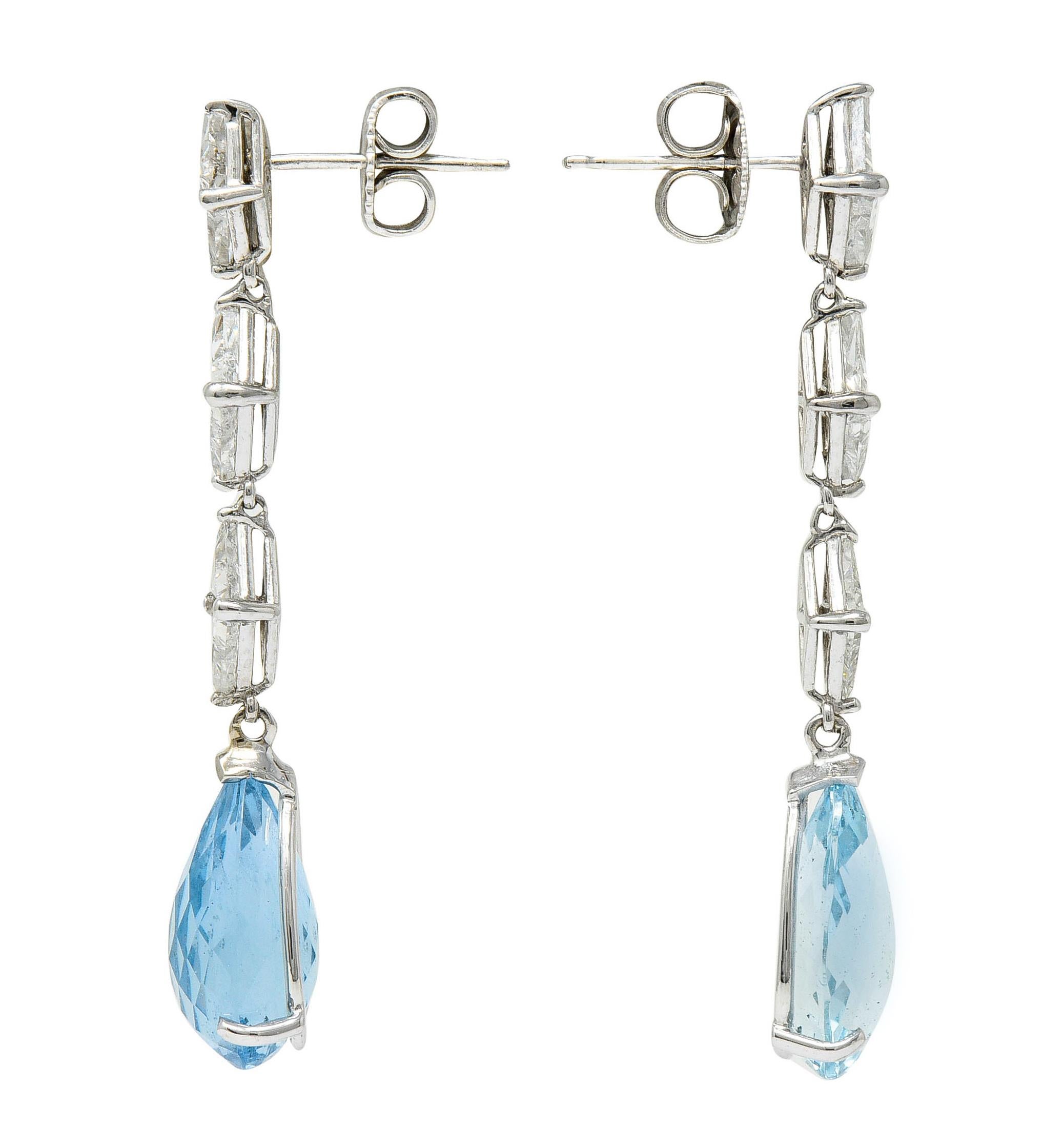 Elongated drop earrings feature surmounts comprised of triangle step cut diamonds

Weighing approximately 1.80 carats with well-matched G to J color and VS to SI clarity

Basket set as three articulated links suspending a briolette cut