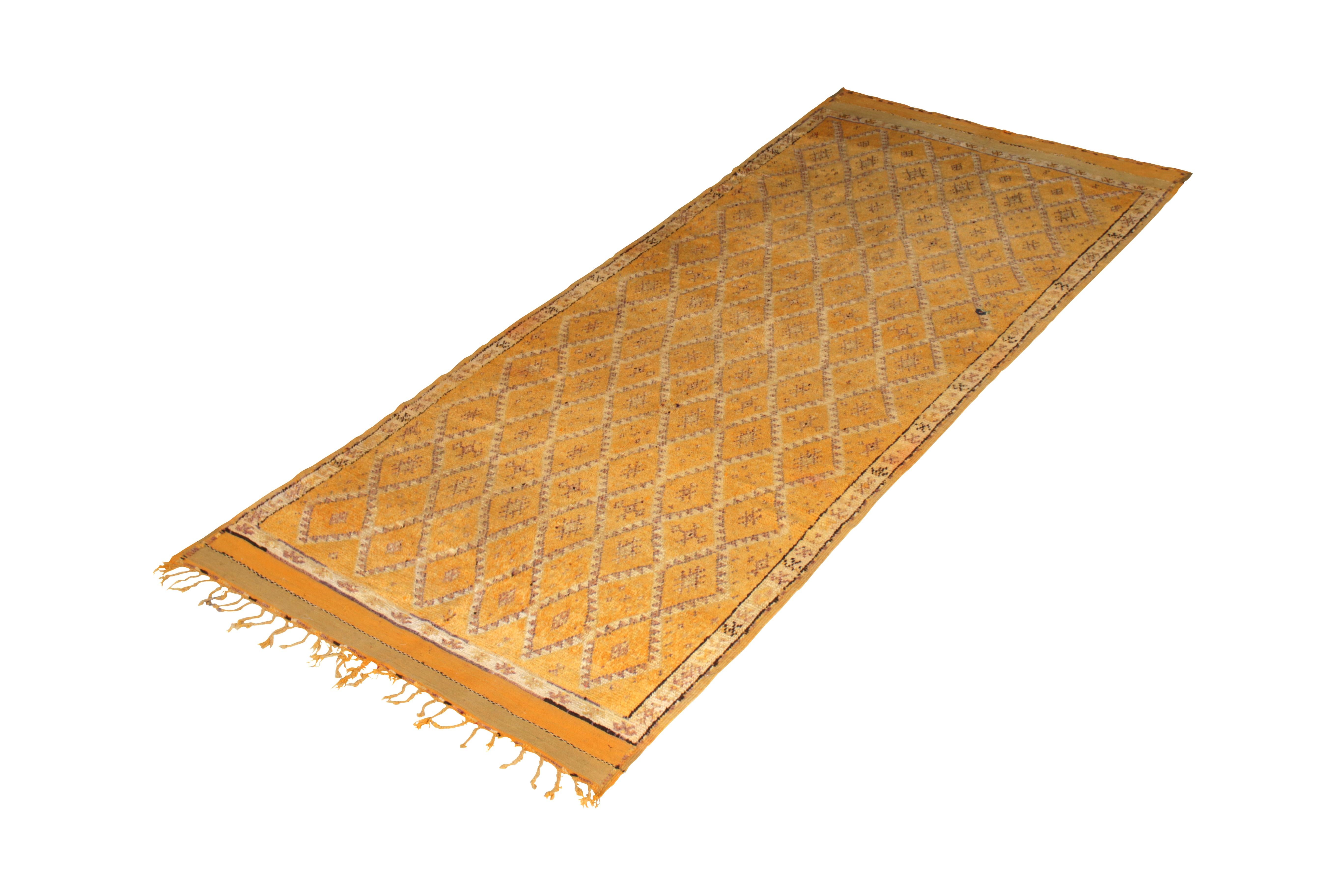 Hand knotted in wool originating from Morocco circa 1950-1960, this vintage mid-century Moroccan rug hails from the Berber tribal weavers of renown, among the most celebrated archetypal families of the hand knotted rug tradition. This particular