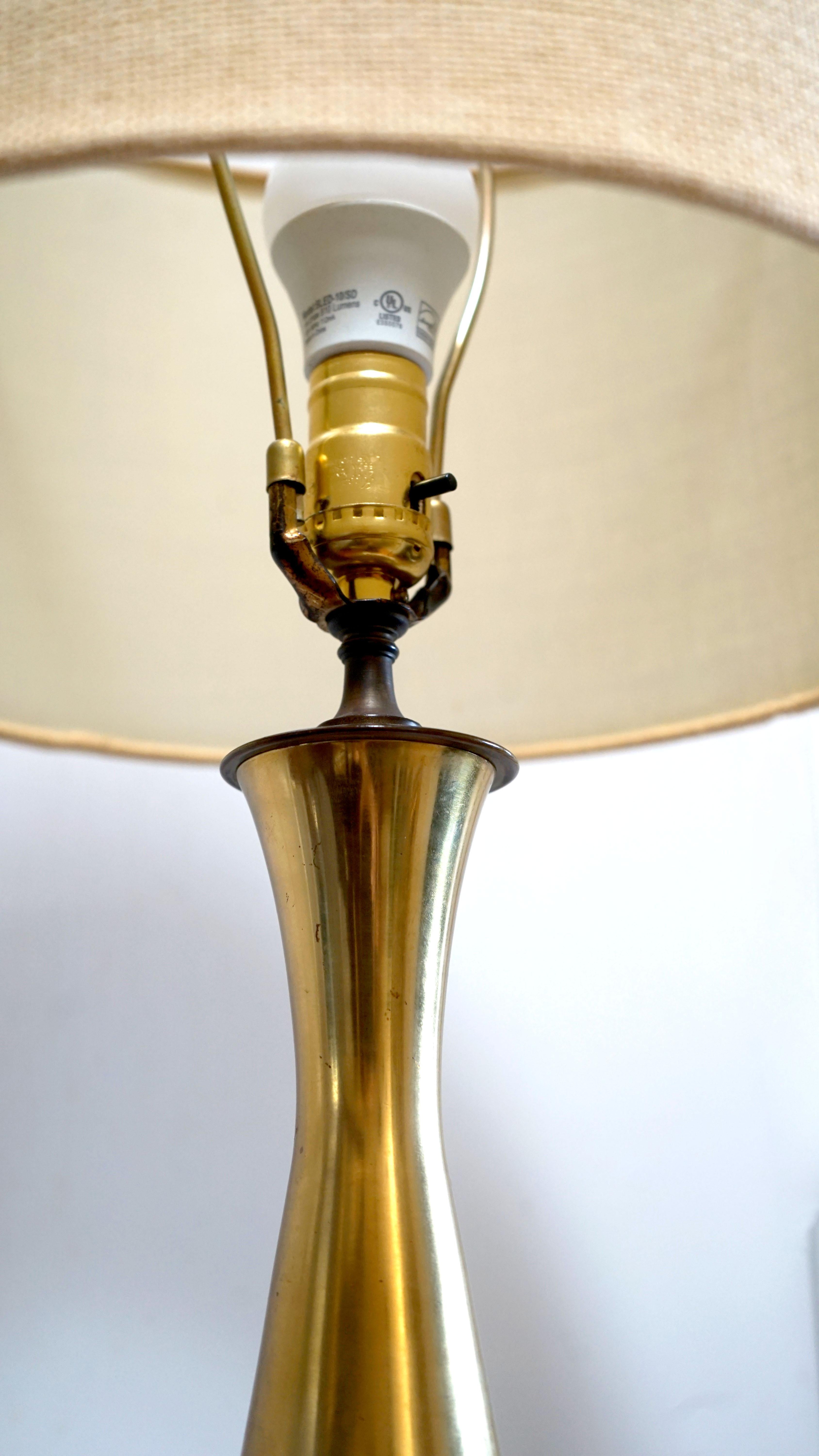 This is a beautifully designed Danish style vintage brass lamp on a walnut base. The style is Danish, probably mid 20th century from the 1950s made in Europe or the U.S.
The form is incredible--with its tear drop shape, flaring neck and pinched