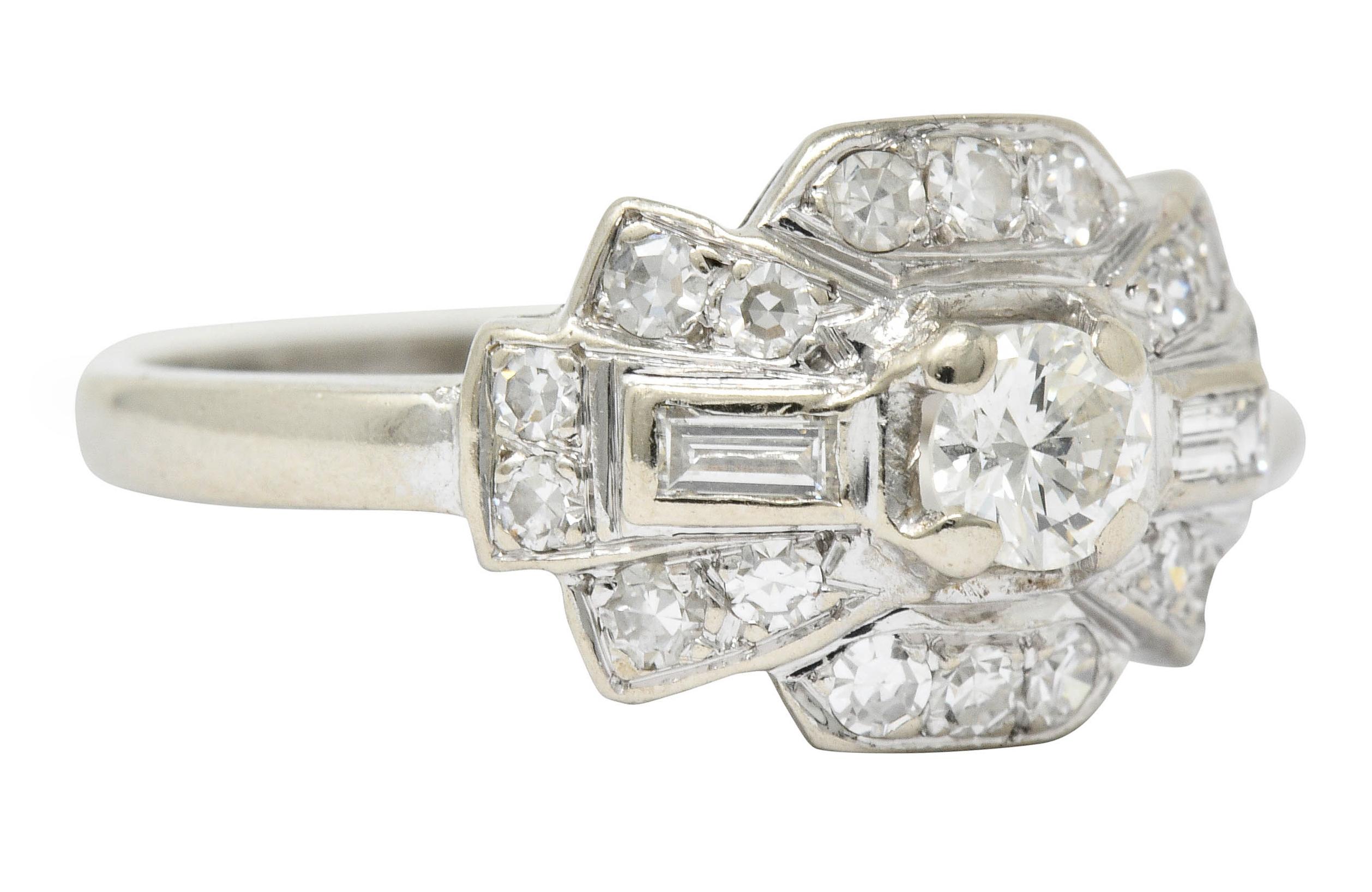 Band style ring designed as a stylized bow motif centering a round brilliant cut diamond weighing approximately 0.25 carat; J color and VS clarity

Flanked by two baguette cut diamonds weighing approximately 0.15 carat; eye-clean and