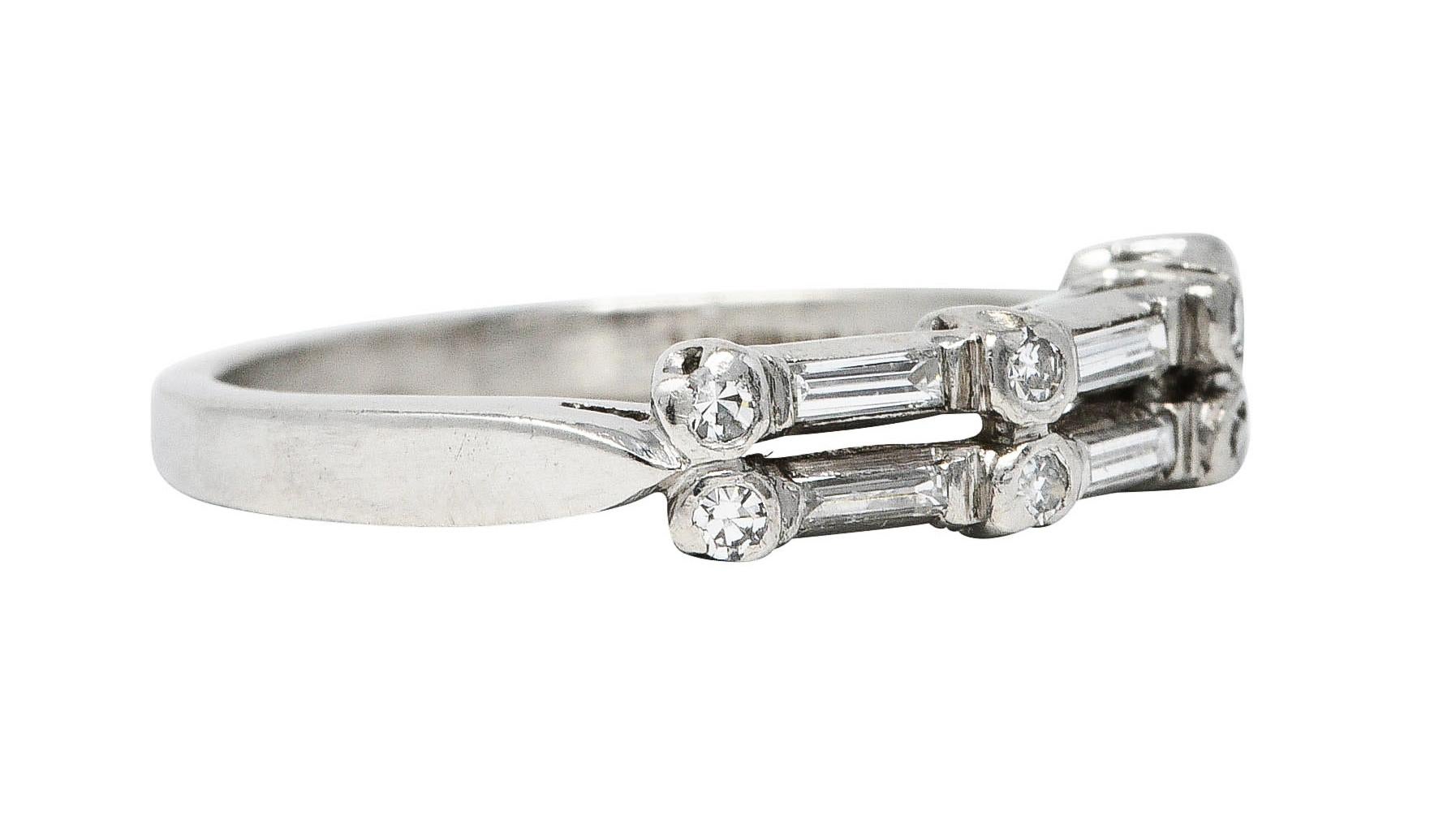 Band ring is comprised of two rows of baguette and single cut diamonds

Alternating in a dot and dash motif

While weighing in total approximately 0.65 carat with G to I color and VS to SI clarity

With maker's mark and stamped for platinum

Circa: