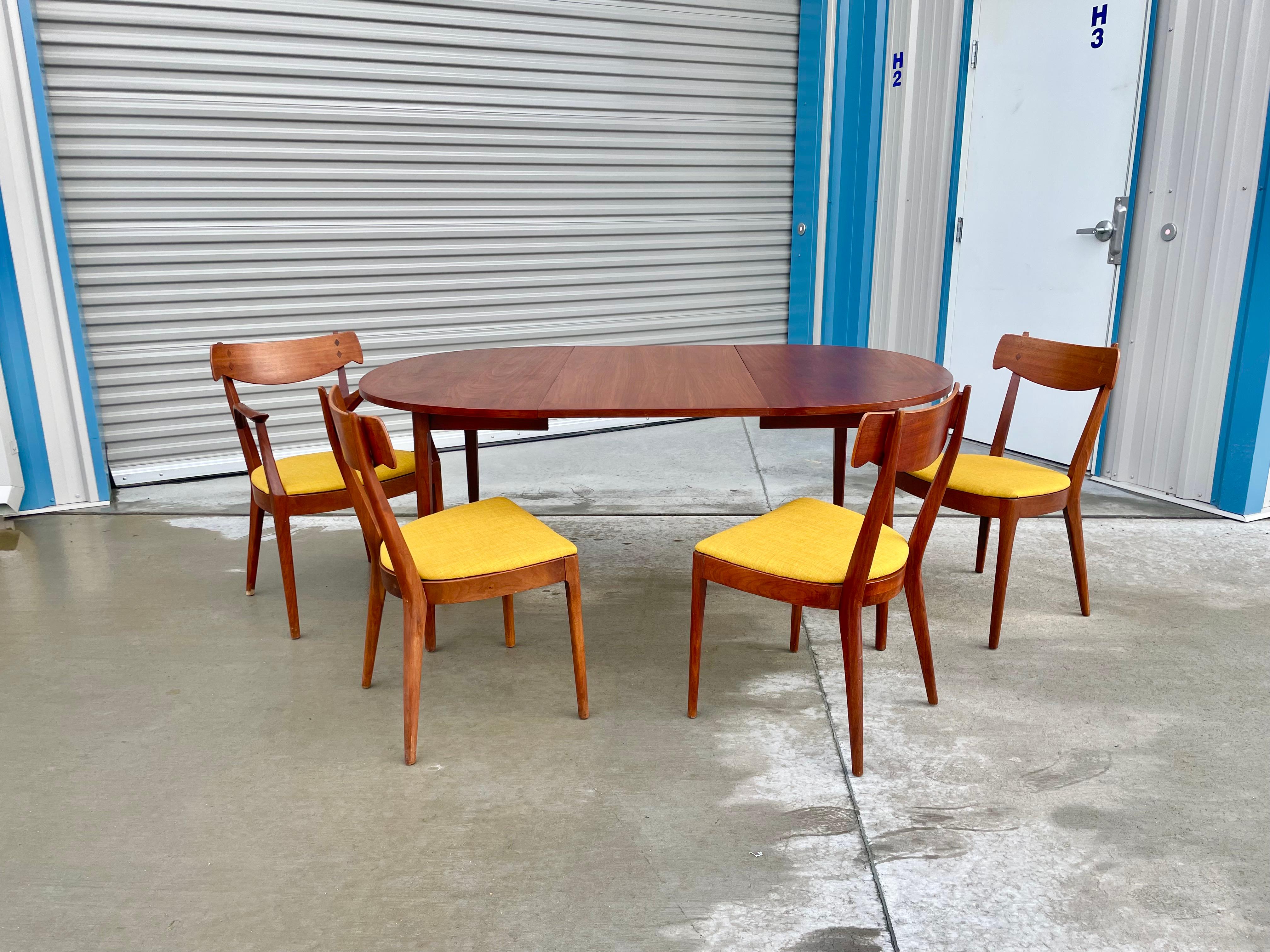 Midcentury dining room set was designed by Kipp Stewart and manufactured by Drexel in the United States circa 1950s. This beautiful dining room set features a dining table with one leaf extension creating more space for you and your guest. The set
