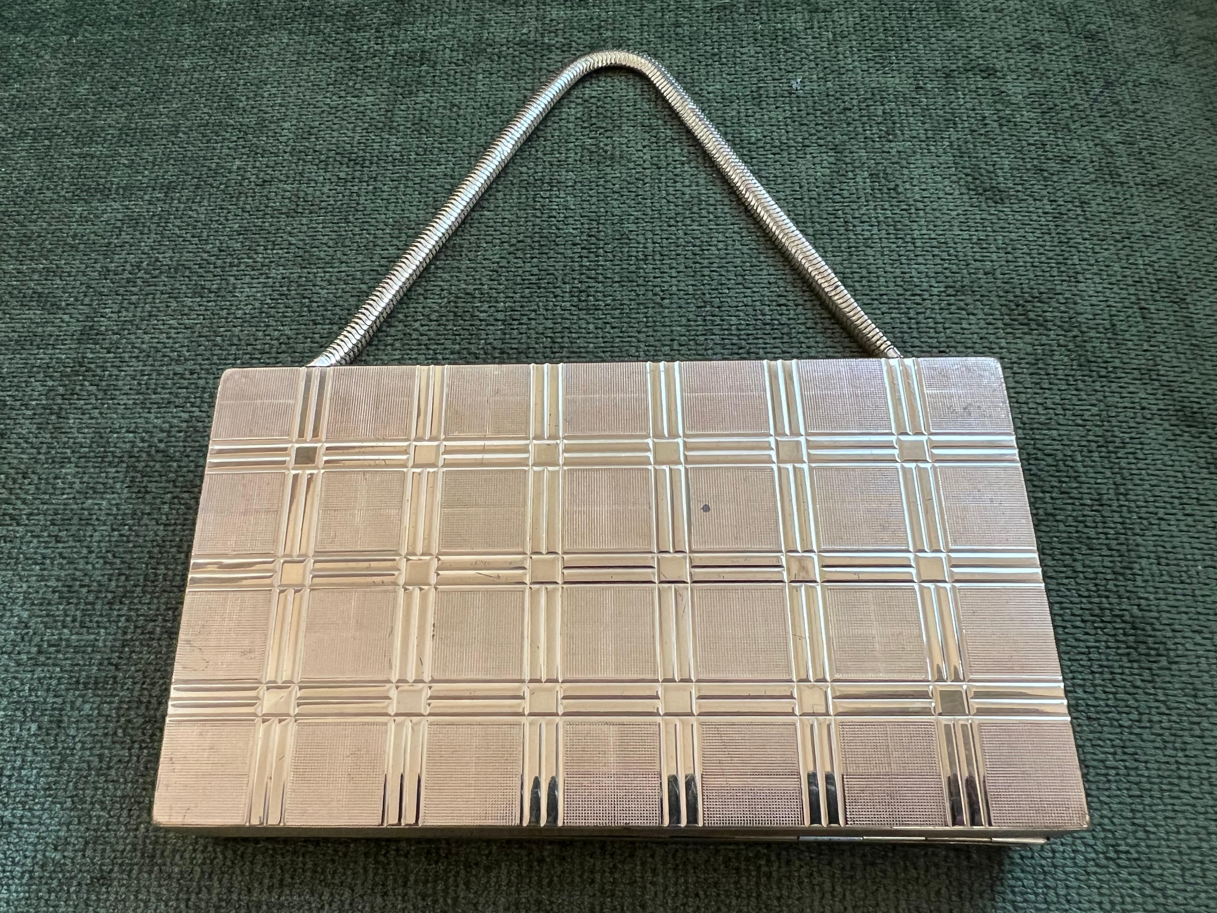 This 1950s mid-century EVANS wristlet compact vanity kit and cigarette case.
Cover still has the pressed powder, gold lipstick case , and the powder puff. This elegant vintage wristlet is in excellent condition and perfectly giftable in quality and