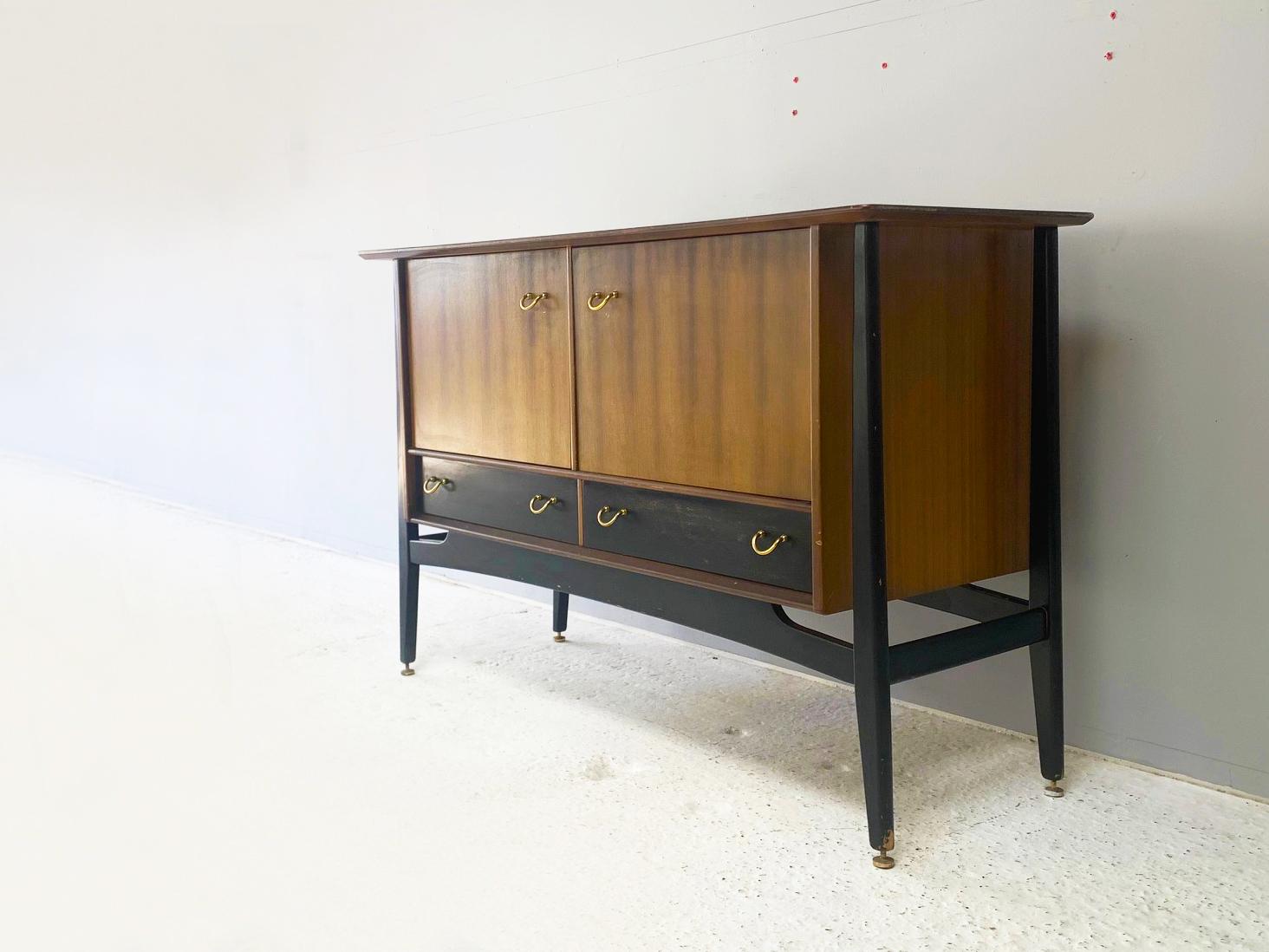 A G Plan Tola & Black sideboard produced in the late 1950’s

The G Plan Tola & black Librenza range preceded the company’s lean towards Danish design aesthetic in the 1960’s. 

’Tola’ is the name of the African mahogany used throughout the