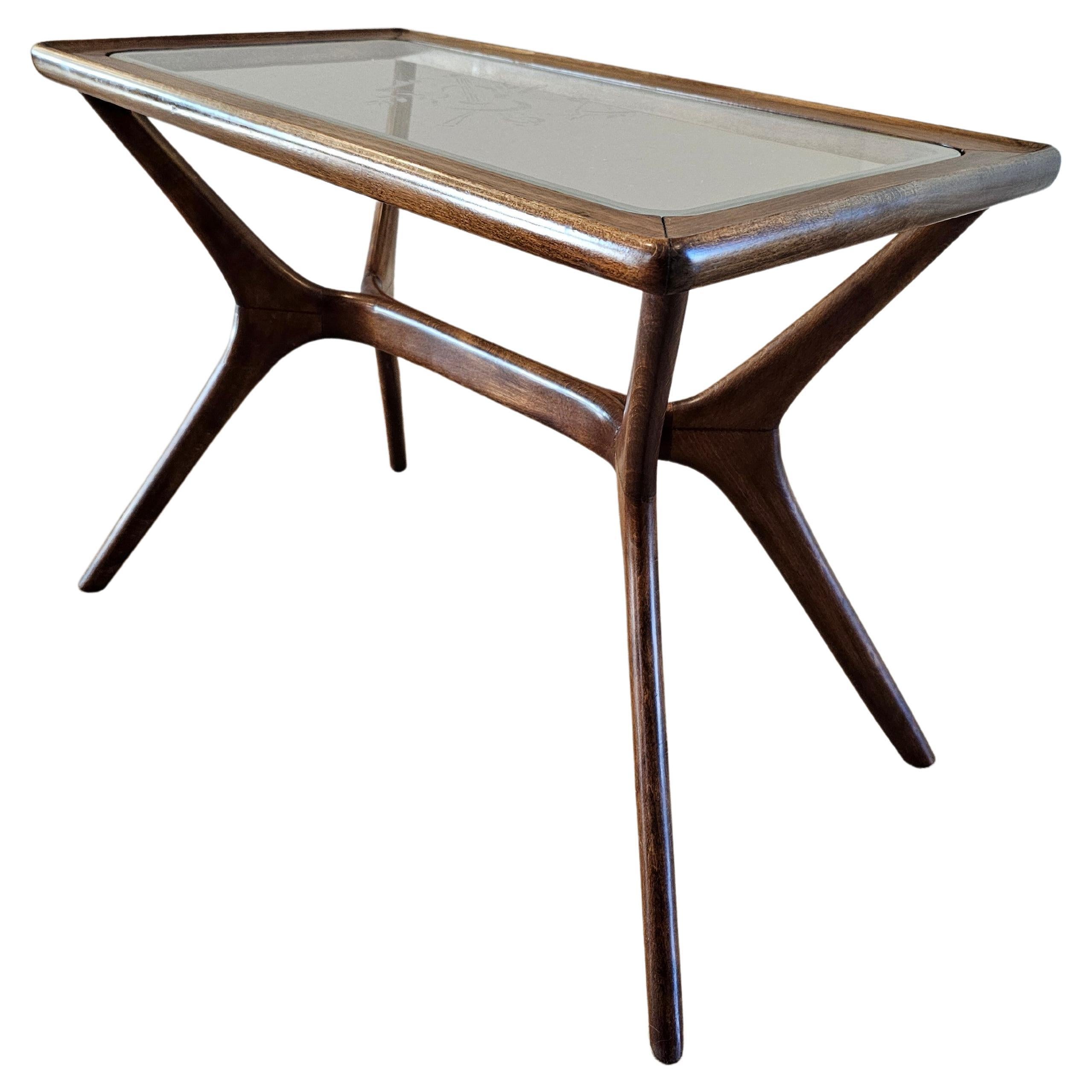 An original mid-century modern side table, in the manner of legendary Italian modernist architect and designer Ico Parisi (1916-1996)

Italy, circa 1950s, having a rectangular inset glass tabletop with sophisticated etched violin design, rising on a