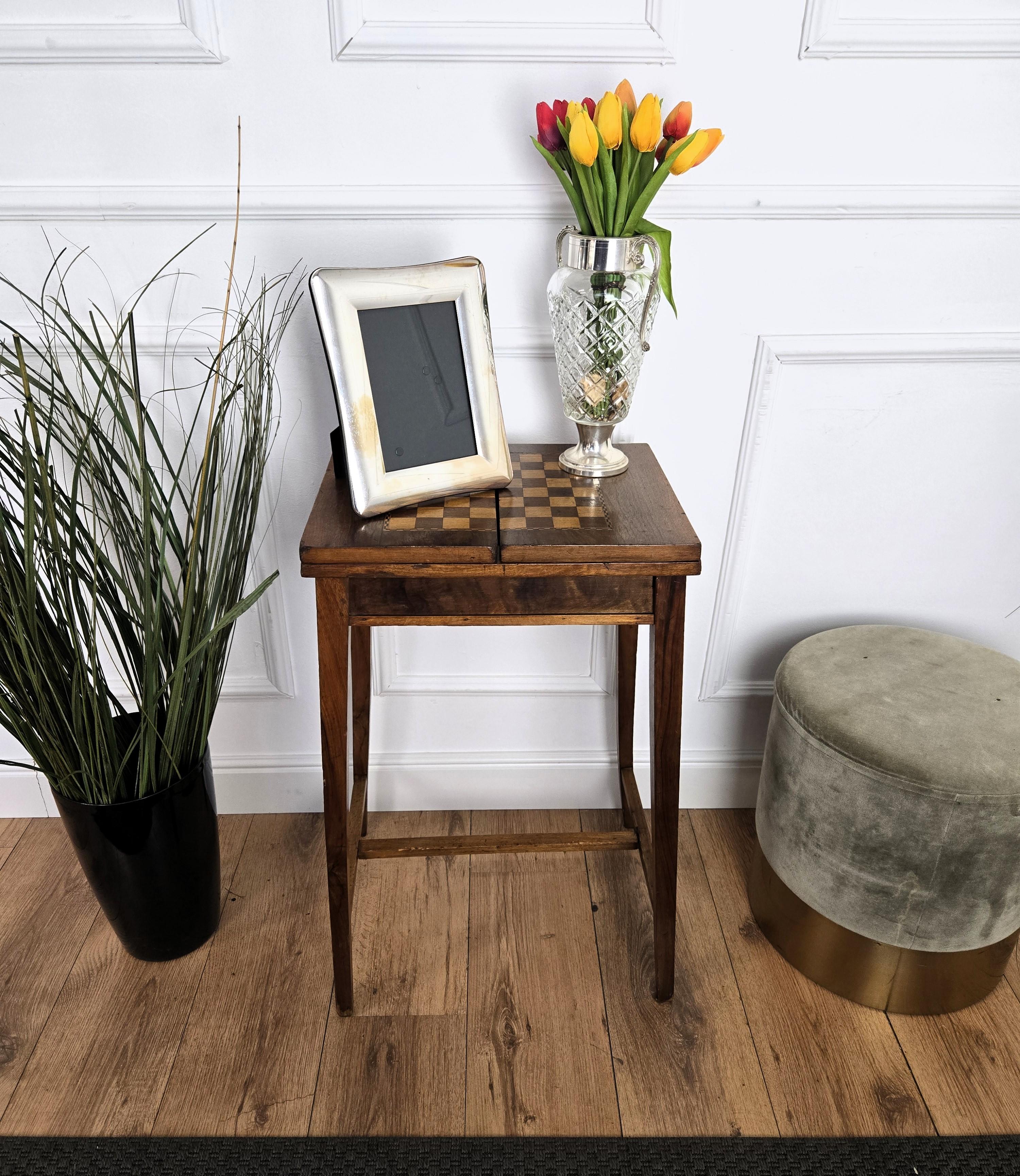 Beautiful Italian solid walnut games side table with inlay chess game over four classic simple legs connected to one another with central stretchers and central opening with storage compartments. This Italian walnut side table with the rich and