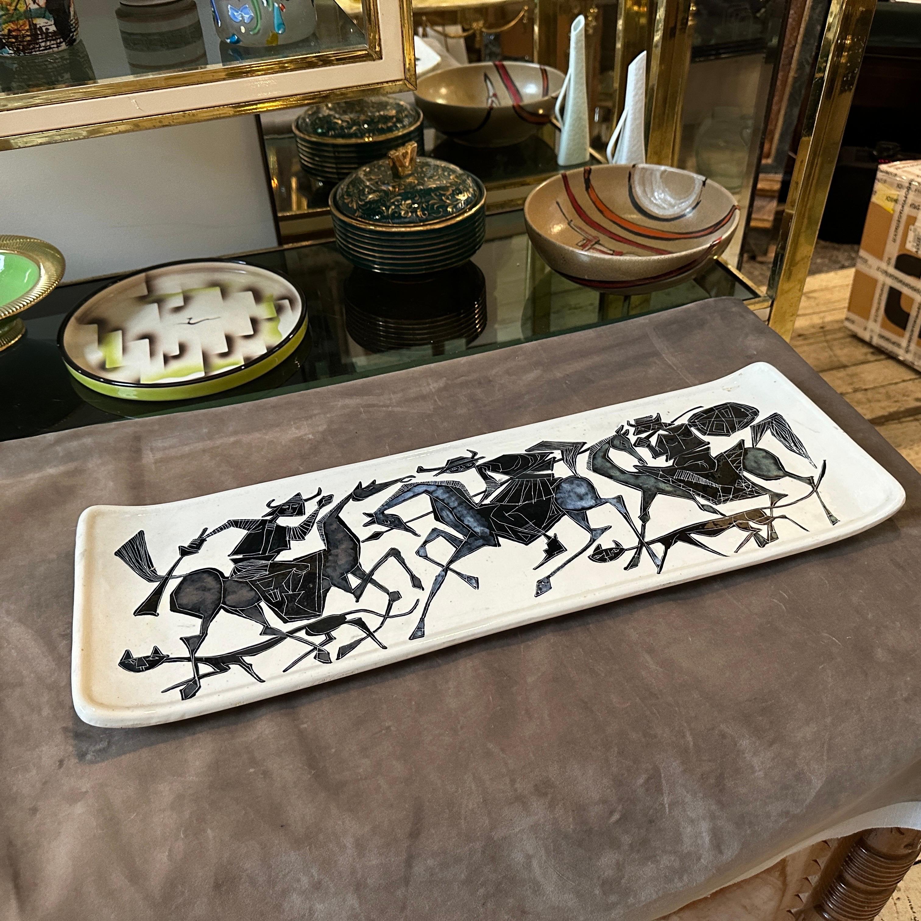 A big ceramic wall plaque hand-crafted and painted in San Marino in the Fifties, the black decor depicts some cavaliers, it' is a striking piece of art that reflects the intricate craftsmanship and artistic traditions of the period. San Marino,