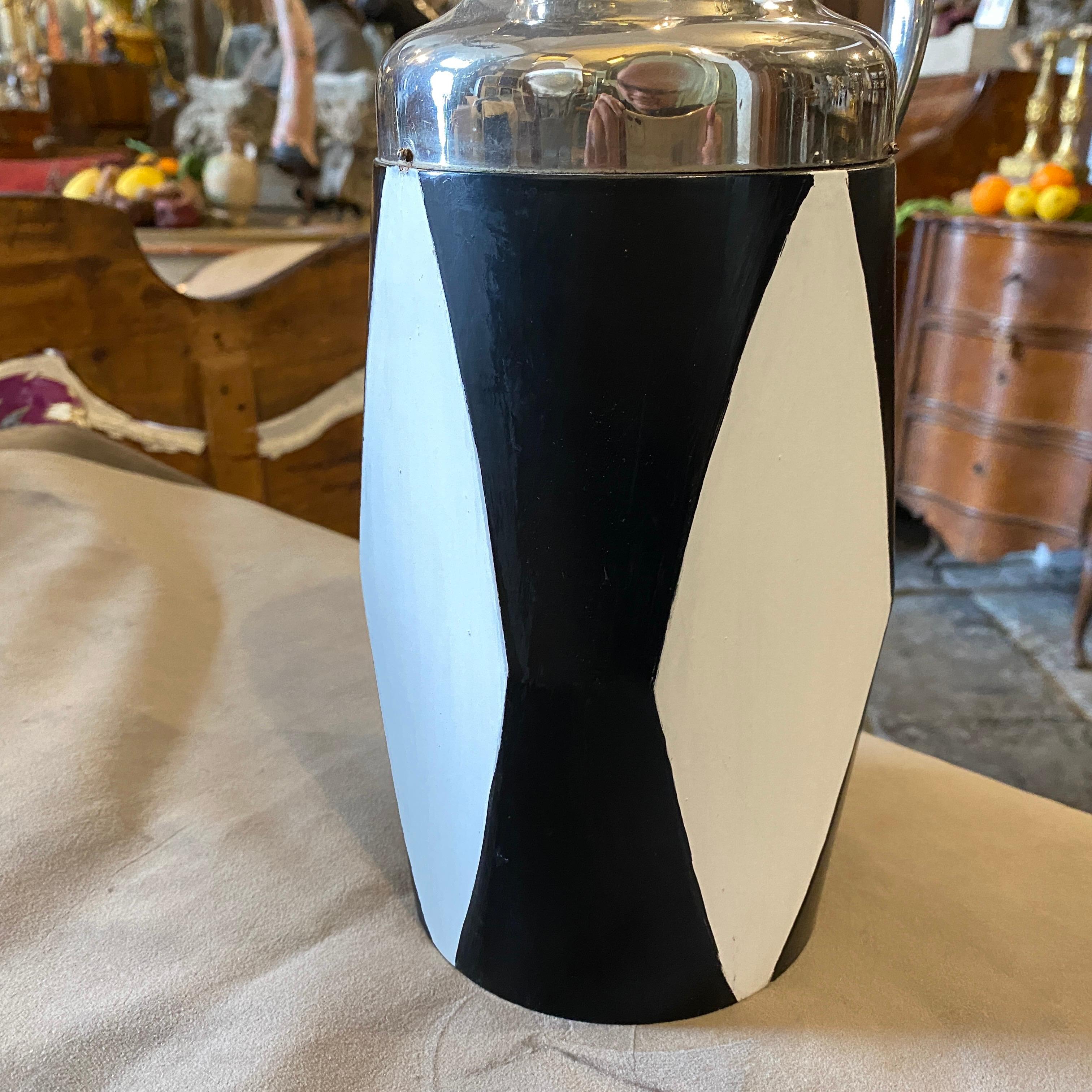 A stylish black and white painted wood and silver plate thermos carafe in the style of Aldo Tura.