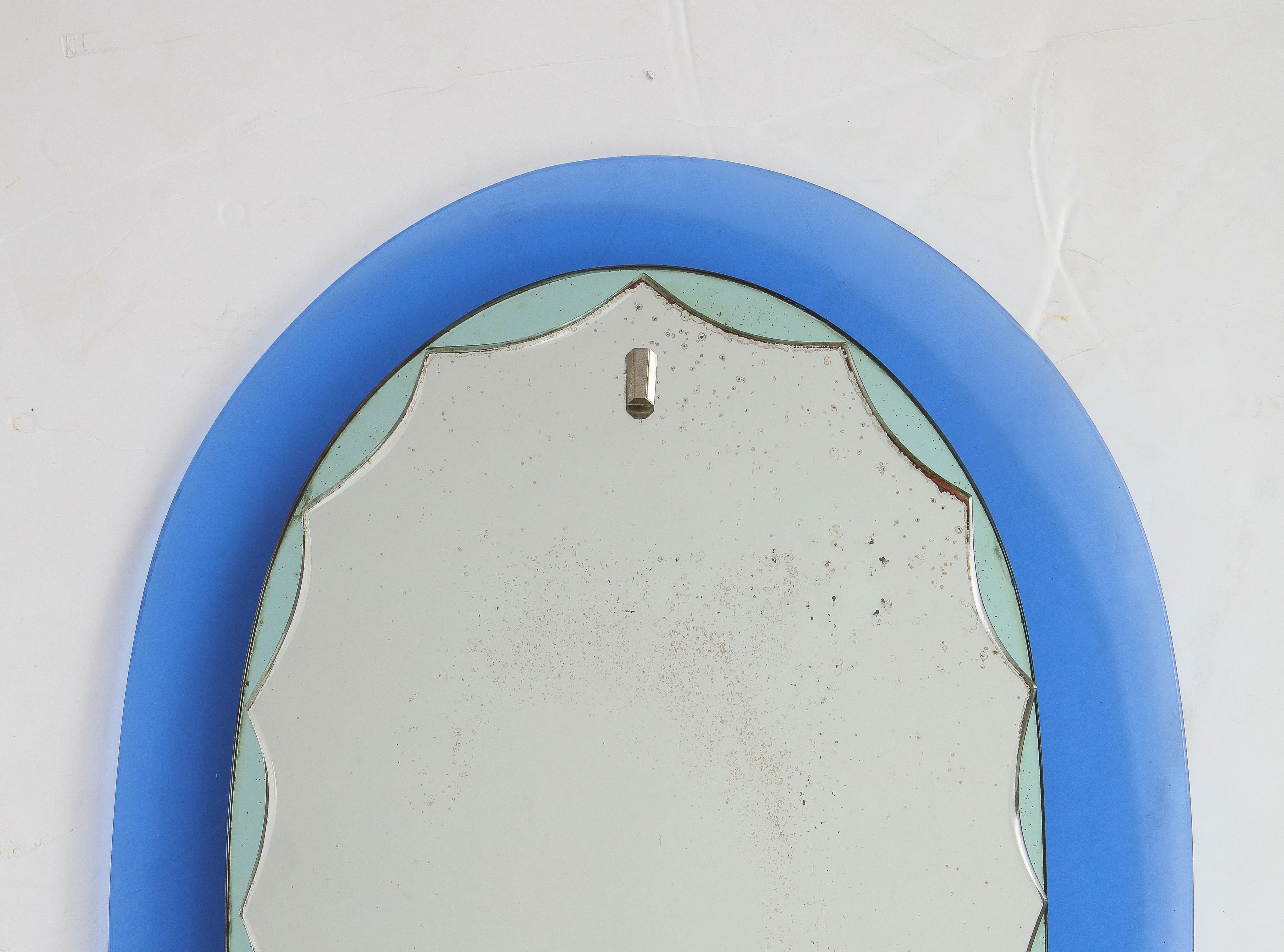 Stunning 1950's Mid-Century Modern blue frame with scalloped green mirror detail and brass hardware Italian mirror, in vintage original condition with some wear and patina due to age and use.