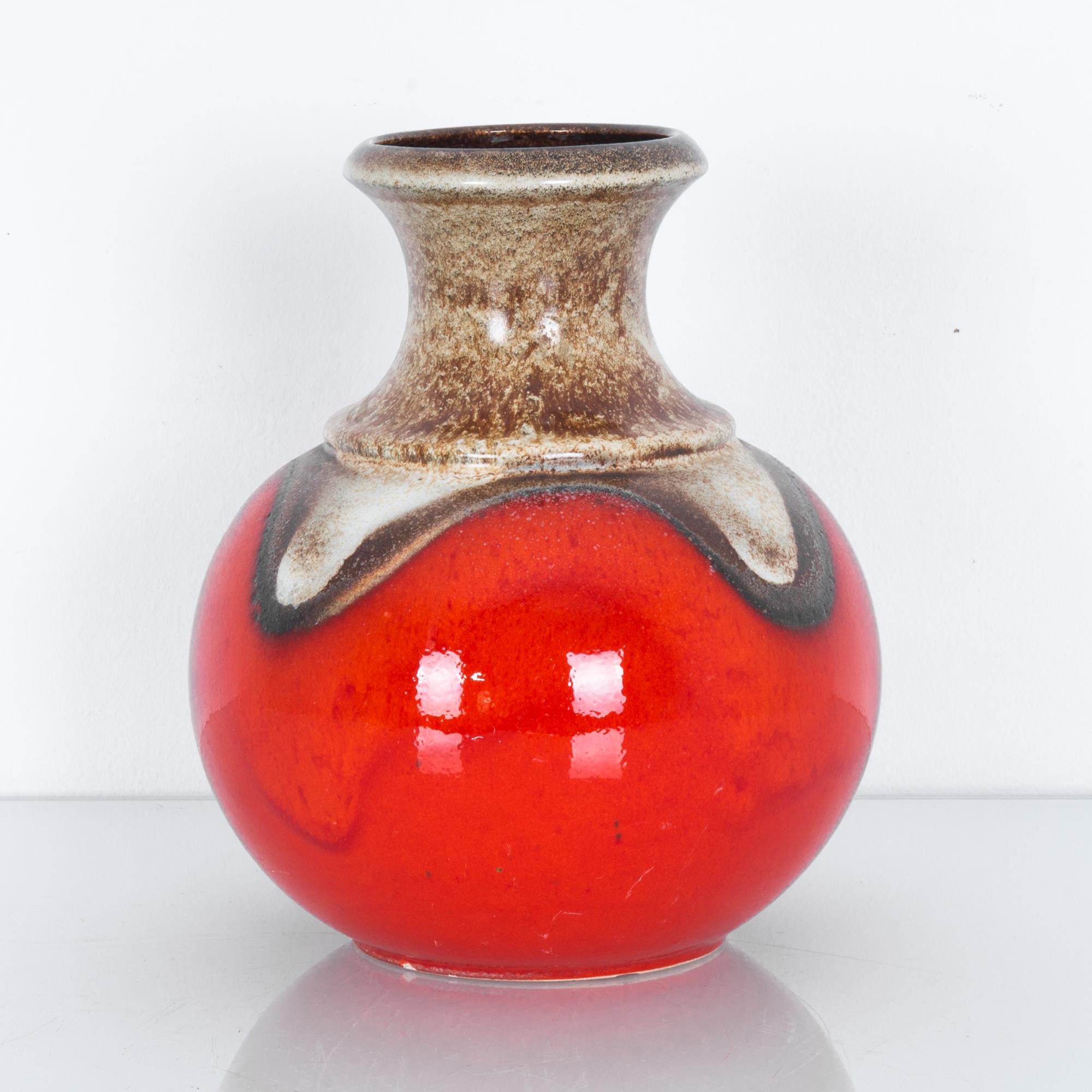 A graphic patterned vase from Germany, circa 1950. Glazed in brown and red, these characteristic mid-20th century ceramics were produced in West Germany by a range of makers. High quality stoneware, with graphic midcentury color schemes and