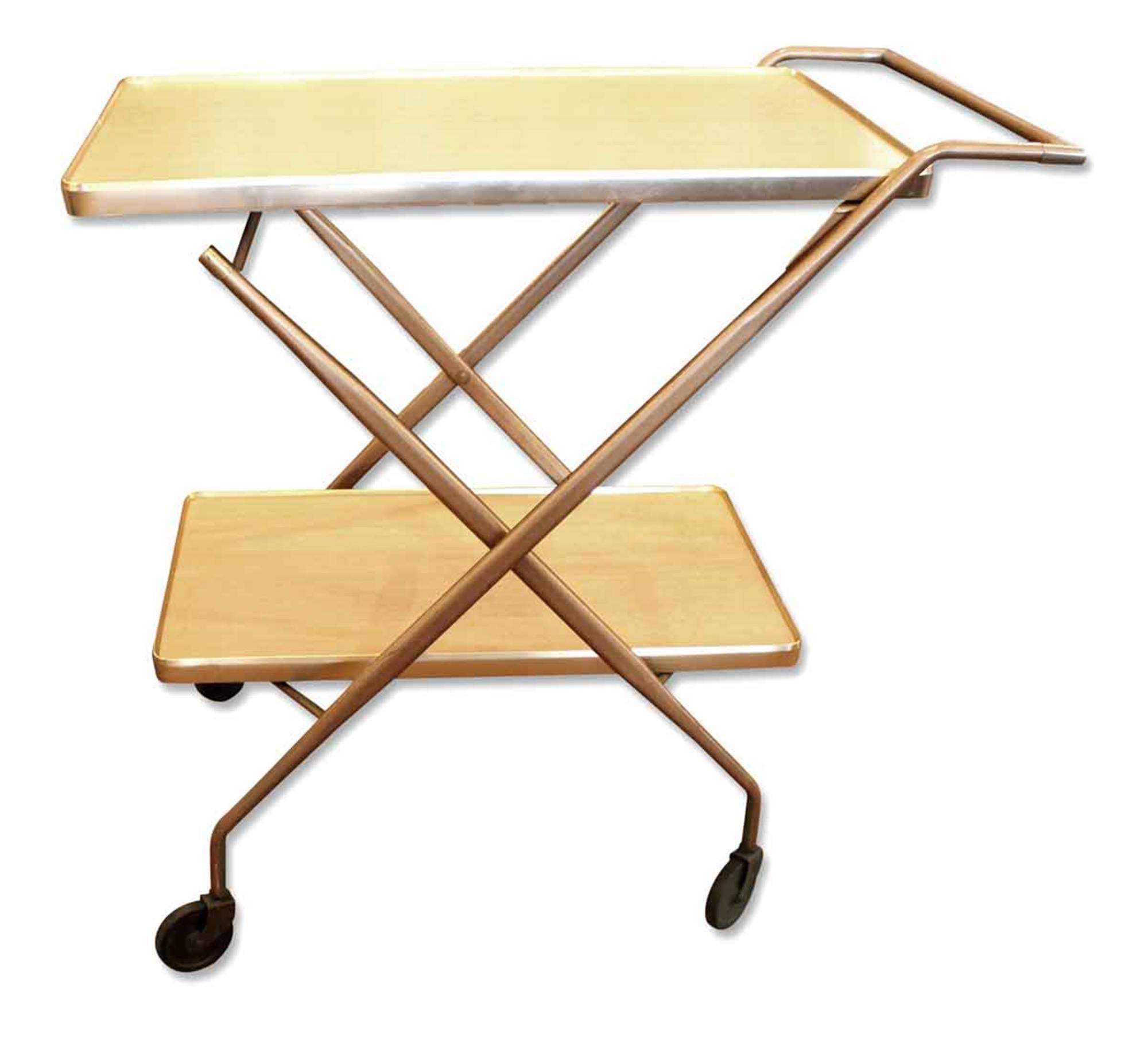 Simple 1950s Mid-Century Modern folding serving cart with a brass frame and formica shelves. This can be seen at our 2420 Broadway location on the upper west side in Manhattan.